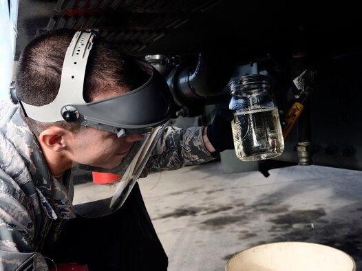 Airman 1st Class Keith Emberton, a fuel specialist and distribution driver with the 6th Logistics Readiness Squadron, checks a fuel sample for particles at MacDill Air Force Base, Fla., Jan. 6, 2016. Fuel samples are taken and checked every day to ensure the filter system is working and the fuel stays clean and free of water. If water makes its way into the aircraft it can cause the engines to not start or shut off midflight. (U.S. Air Force photo by Senior Airman Tori Schultz) 