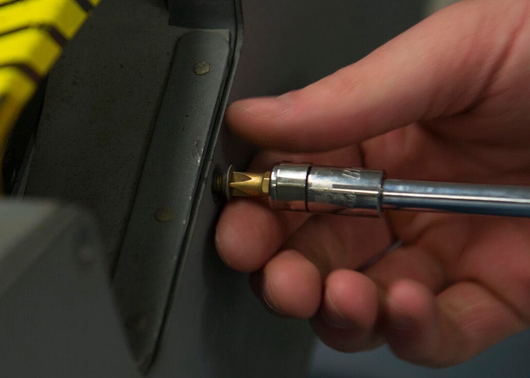 U.S. Air Force Airman 1st Class Eric Hedgepeth, an egress systems journeyman assigned to the 1st Maintenance Squadron, removes a panel from the side of T-38 Talon seat at Langley Air Force Base, Va., Jan. 8, 2016. Aircrew egress systems specialists handle and maintain explosive devices used to operate escape systems. (U.S. Air Force photo by Staff Sgt. J.D. Strong II)