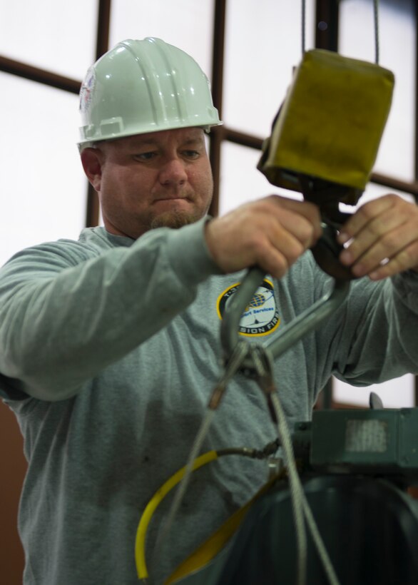 Jason Clem, an aircraft mechanic from M1 Support Services, detaches a T-38 Talon seat from an east-west crane at Langley Air Force Base, Va., Jan. 8, 2016. Clem, a U.S. Air Force veteran, served at Langley in the 1st Component Squadron Maintenance Squadron. (U.S. Air Force photo by Staff Sgt. J.D. Strong II)