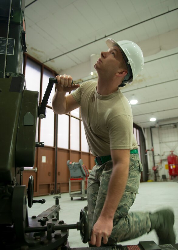 U.S. Air Force Airman 1st Class Eric Hedgepeth, egress systems journeyman assigned to the 1st Maintenance Squadron, uses an east-west crane to remove a T-38 Talon seat at Langley Air Force Base, Va., Jan. 8, 2016. Hedgepeth has served as an egress systems technician for two years. (U.S. Air Force photo by Staff Sgt. J.D. Strong II)