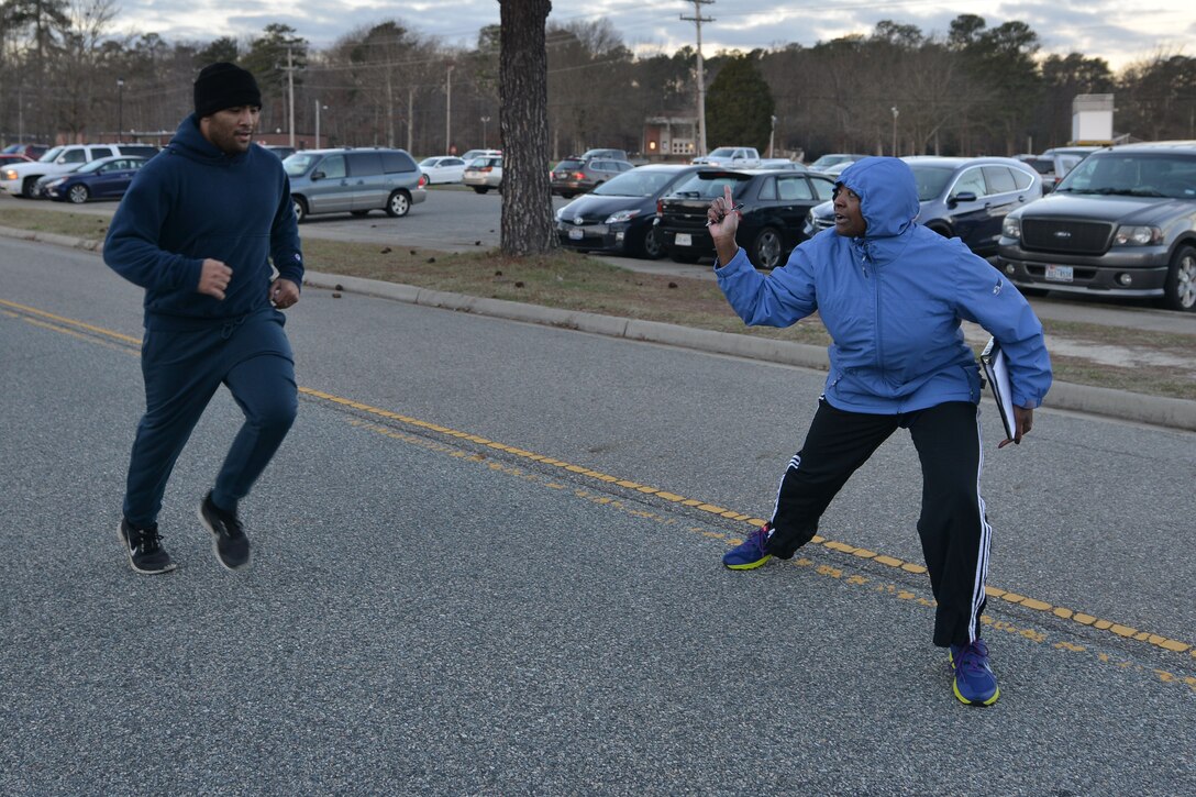 Darlean Basuedayva, a Fort Eustis Health Promotions Officer, encourages a participant during the 5K kickoff of the Civilian Commander’s Cup Challenge at Fort Eustis, Va., Jan. 7, 2015. During the six-month challenge, participants track their physical activity for points. (U.S. Air Force photo by Staff Sgt. Natasha Stannard)