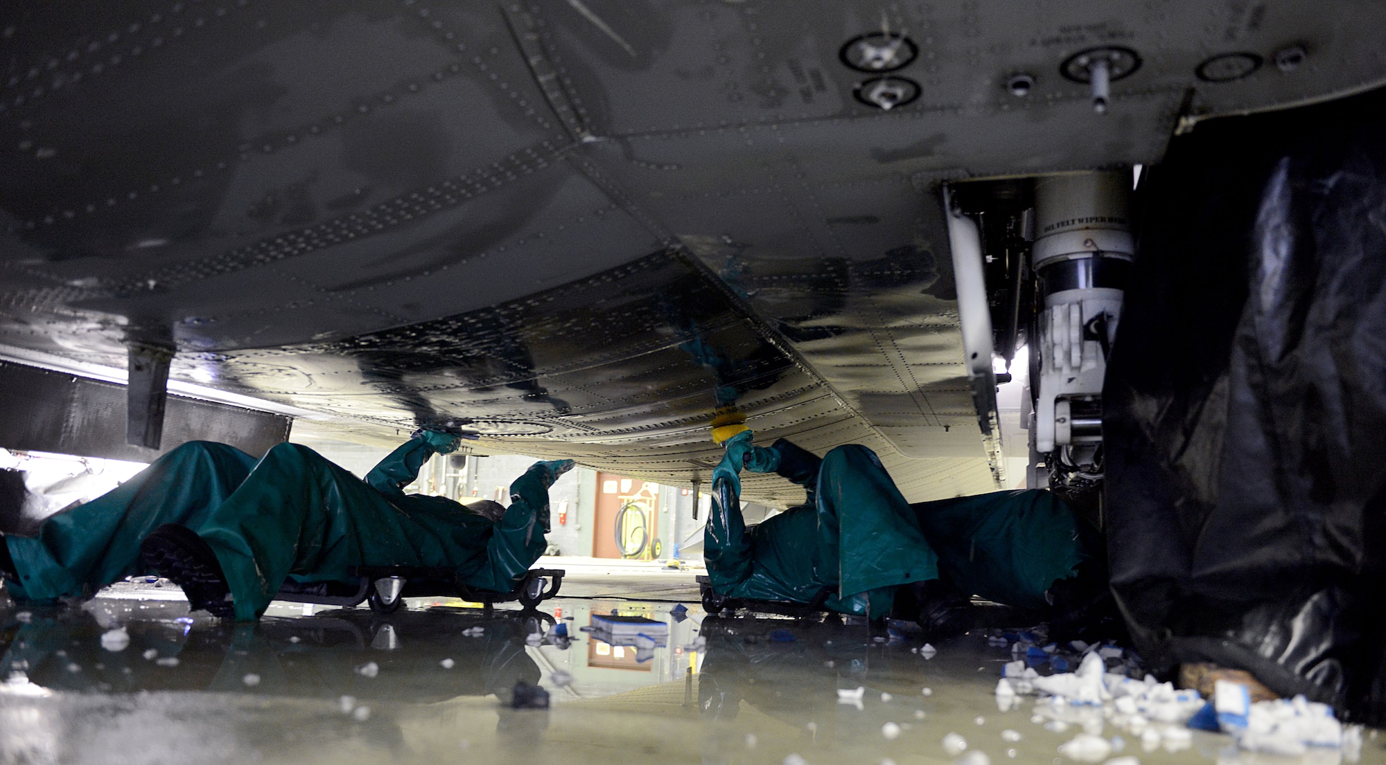 Capt. Rachel Weiler, left, 86th Maintenance Squadron maintenance flight commander, and Senior Airman Kyle Warnock, 86th MXS crew chief clean the underbelly of a C-130J Super Hercules during a pre-isochronal (ISO) inspection wash Jan. 4, 2016, at Ramstein Air Base, Germany. An ISO inspection is a scheduled, extensive examination of an aircraft to maintain its functionality and perform preventive maintenance. This examination marks the 14th and final C-2 ISO inspection, which is the most in-depth ISO inspection, for the 86th Airlift Wing until 2020. The inspection lasts approximately two weeks. (U.S. Air Force photo/Staff Sgt. Timothy Moore)