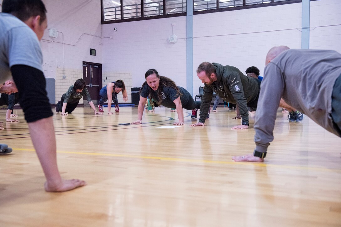 PETERSON AIR FORCE BASE, Colo. - Special Agents from the 8th Field Investigations Squadron of the Air Force Office of Special Investigations do pushups Jan. 8, 2015 at the Peterson Air Force Base Fitness Center as they shout the names of the six Airmen killed recently in Afghanistan. The 8 FIS special agents completed a Hero Workout of the Day to honor their fallen comrades and to pay their respects. They also participated in a resiliency session to ensure each agent knows the resources available during stressful life situations as many of the agents knew the Airmen killed in the line of duty. (U.S. Air Force photo by Senior Airman Rose Gudex)