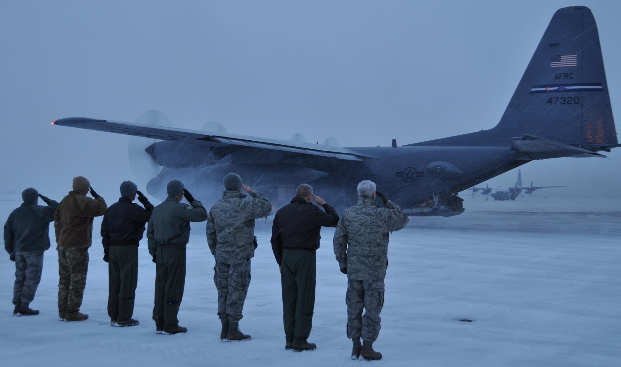 PETERSON AIR FORCE BASE, Colo. – Senior leaders from the Air Force Reserve Command’s 302nd Airlift Wing salute a C-130H aircraft departing Peterson Air Force Base's flightline. Approximately 150 Air Force Reservists and four C-130s from the 302nd Airlift Wing are serving on a four-month deployment to Southwest Asia in support of Operation Freedom’s Sentinel. The aircraft, aircrews and support personnel will provide airlift, airdrop and aeromedical evacuation support to operations throughout the U.S. Central Command Area of Responsibility. (U.S. Air Force photo/Daniel Butterfield)
