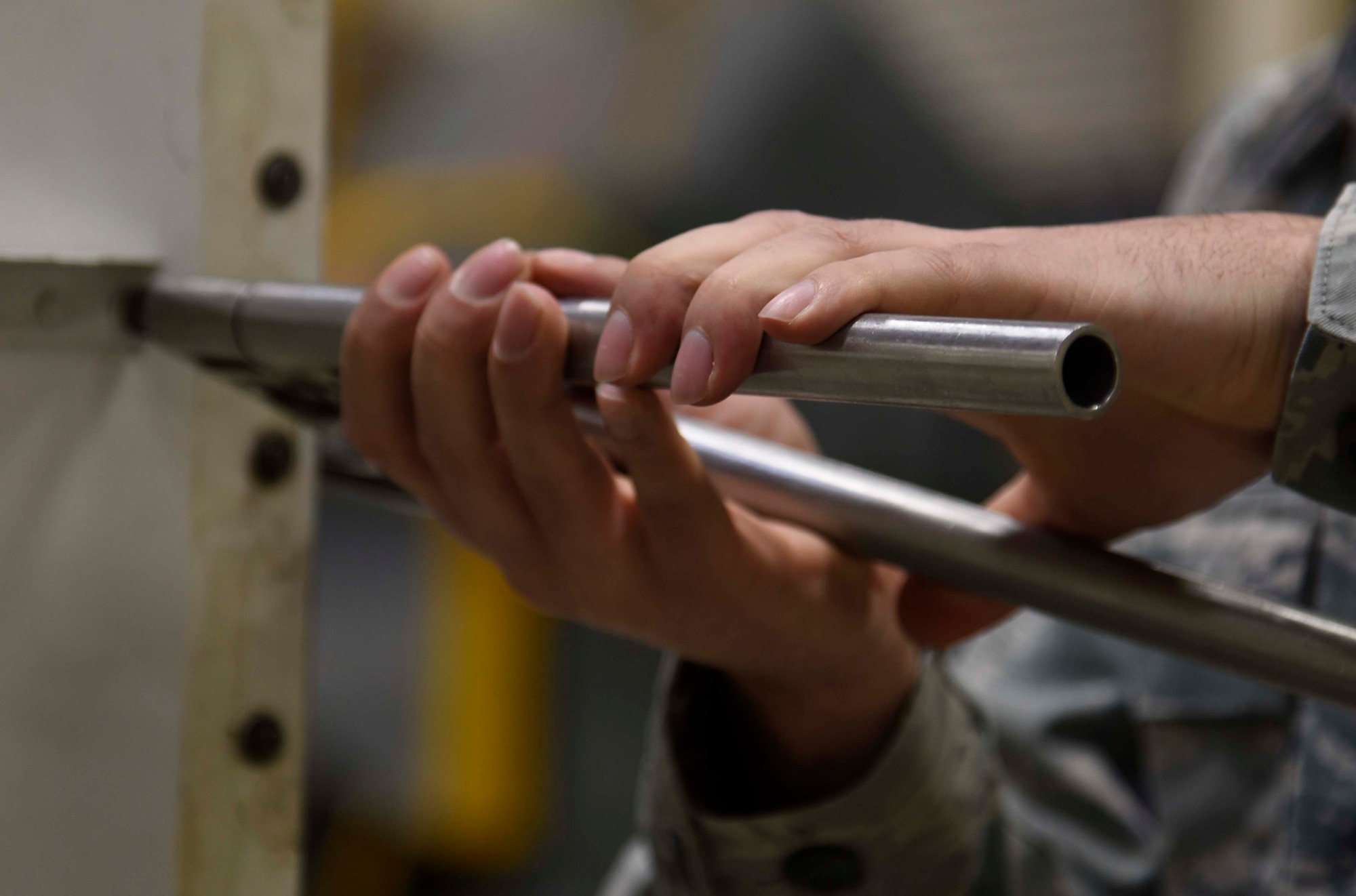 U.S. Air Force Senior Airman Charlton Long, an aircraft structural maintenance journeyman with the 35th Maintenance Squadron, hand squeezes a rivet on an F-16 Fighting Falcon panel at Misawa Air Base, Japan, Jan. 11, 2016. When F-16 rivets succumb to damage or corrosion, the aircraft structural maintenance team services and replaces them to ensure a firm hold to the aircraft frame. (U.S. Air Force photo by Airman 1st Class Jordyn Fetter)