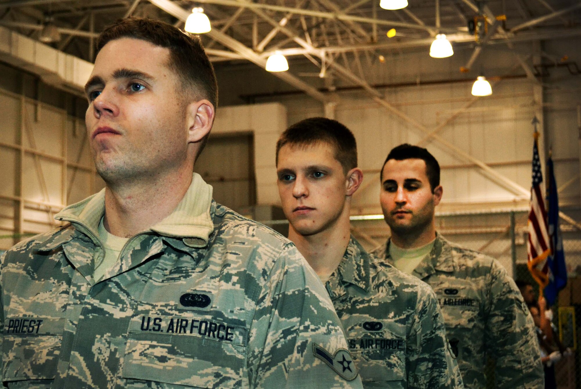 Airman Dustin Priest, a 111th Attack Wing cyber systems operator, (left), Airman 1st Class Randy Czerviski (middle) and Airman 1st Class Christopher Ryan, both from the 111th Security Forces Squadron, stand at attention during the first practice of the reinvented 111th Attack Wing Honor Guard held Jan. 9, 2015 on the base basketball court at Horsham Air Guard Station, Pennsylvania. Many of the new honor guard members are participating on the team for the first time. (U.S. Air National Guard photo/Tech. Sgt. Andria Allmond)