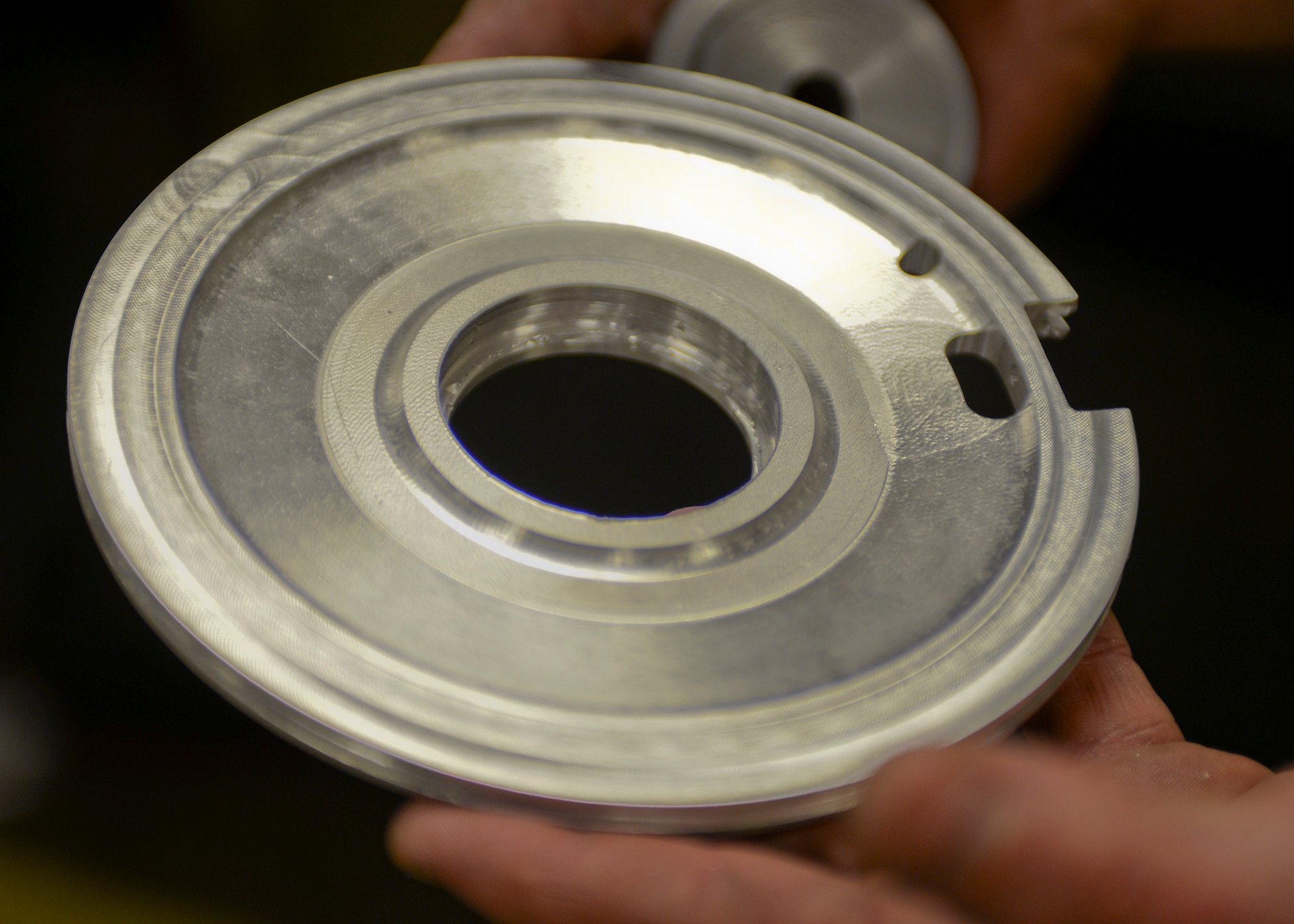 Staff Sgt. Adam Hebert, 28th Maintenance Squadron production supervisor, holds a B-52 Stratofortress drag sheet pulley at Ellsworth Air Force Base, S.D., Jan. 6, 2016. The metals flight creates aircraft parts that cannot be ordered through a supplies list and assists Minot Air Force Base, N.D., at times. (U.S. Air Force photo by Airman Sadie Colbert/Released)
