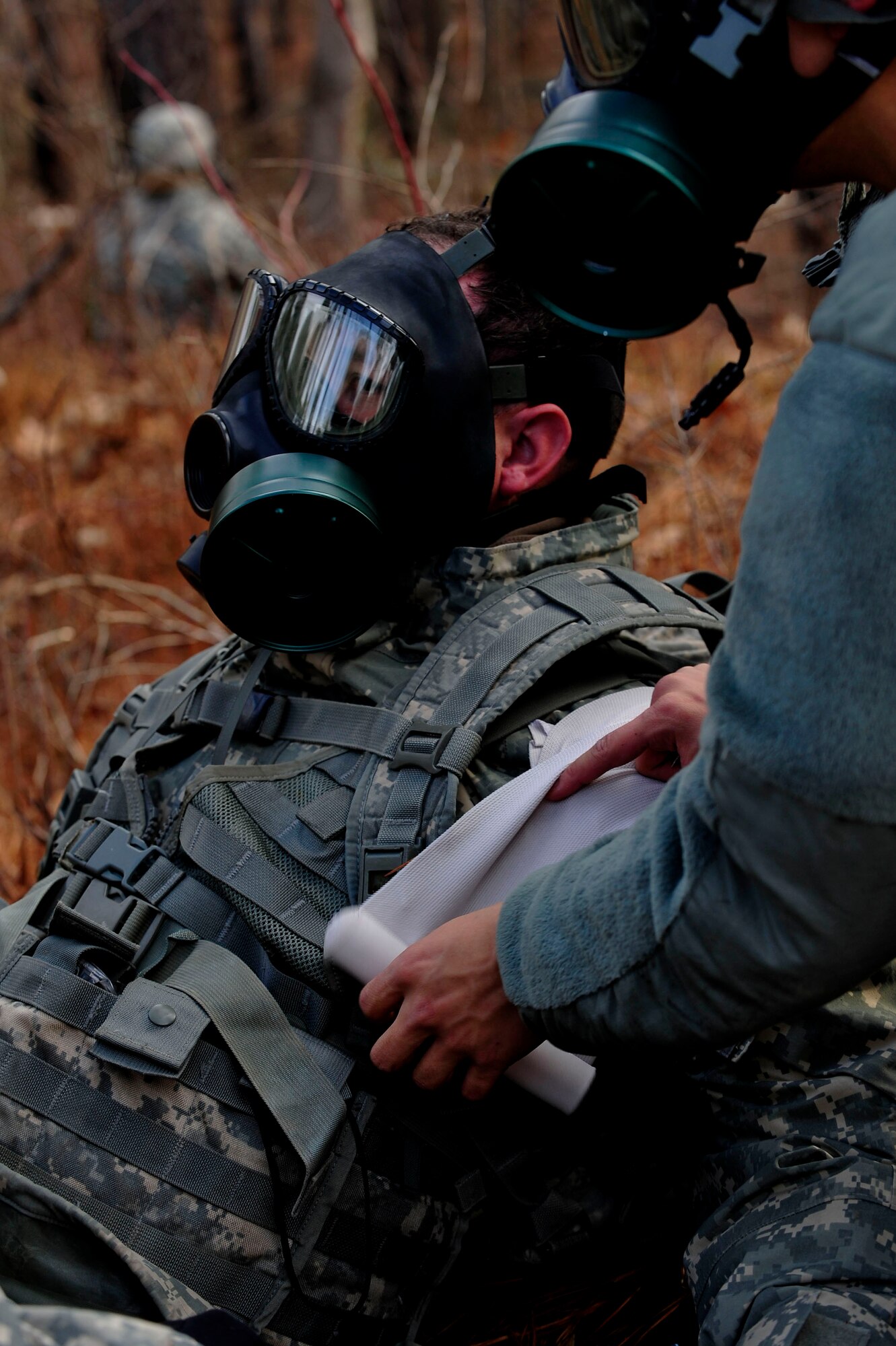 A U.S. Soldier assigned to the 73rd Transportation Floating Craft Company of the 19th Transportation Battalion, 7th Transportation Brigade (Expeditionary), performs simulated emergency medical treatment on a fellow team member during a field training exercise at Fort A.P. Hill, Va., Jan. 12, 2016. The training aimed to refresh the waterbourne Soldiers how to perform basic land-based movements and skills. (U.S. Air Force photo by Senior Airman Breonna Veal)