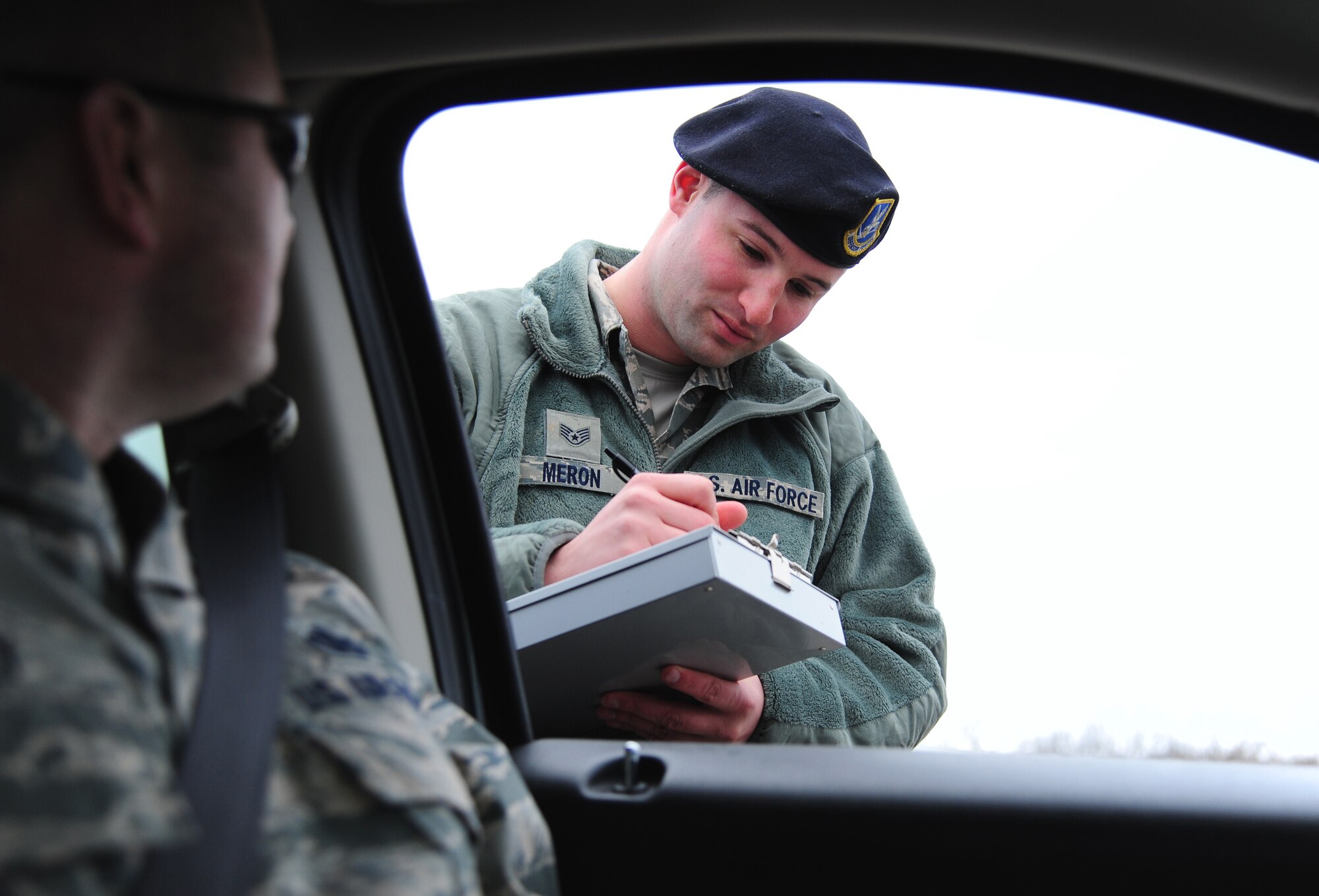 U.S. Air Force Staff Sgt. Mathew Meron, 509th Security Forces desk sergeant, performs a routine traffic stop at Whiteman Air Force Base, Mo., Jan. 6, 2016. As a desk sergeant, Meron is responsible for dispatching Whiteman defenders to any type of emergency happening on base such as medical emergencies, assaults or traffic accidents. (U.S. Air Force photo by Senior Airman Joel Pfiester) 