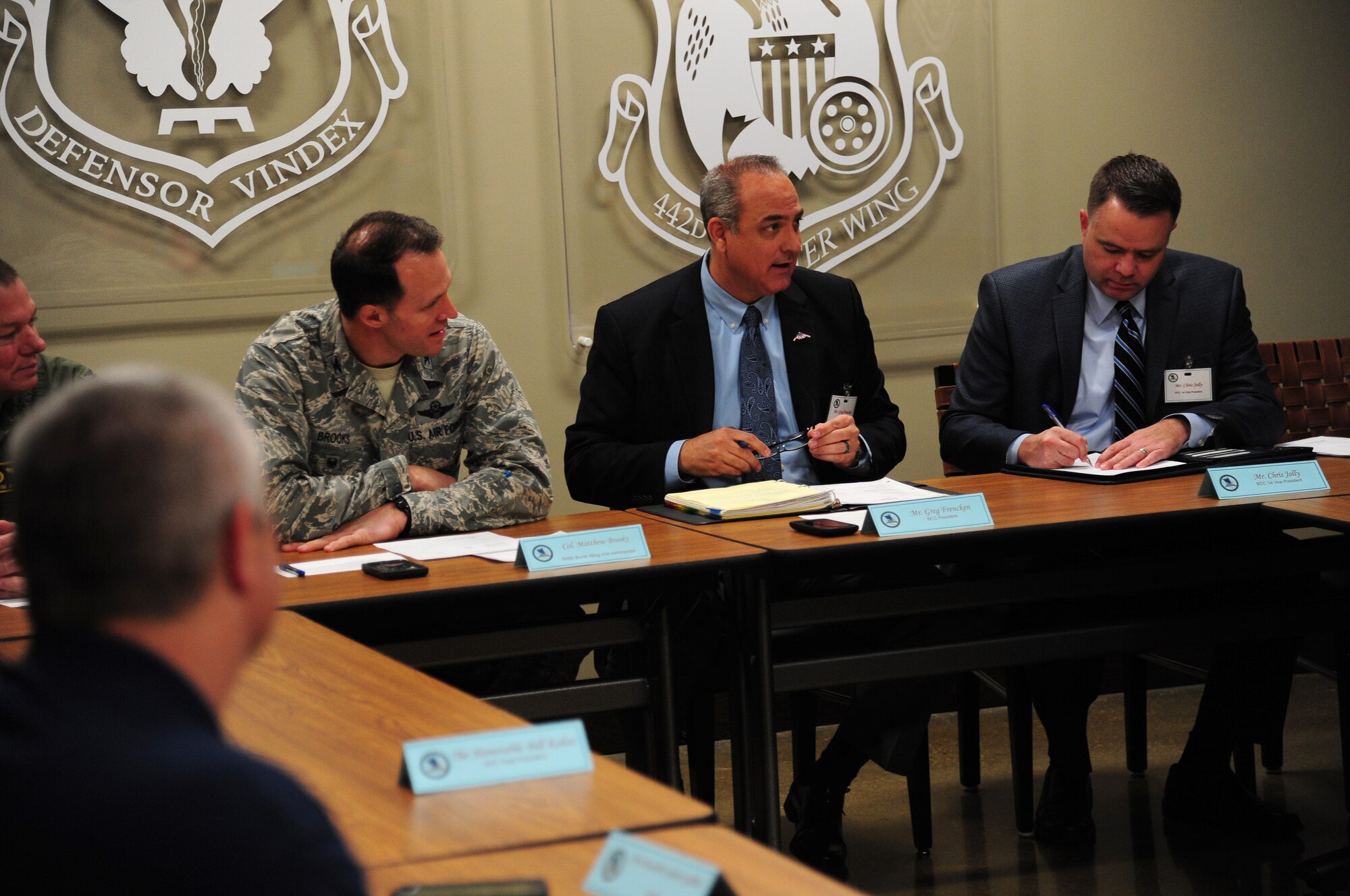 Greg Frencken, the Base Community Council (BCC) president (center), and Col. Matthew Brooks, the 509th Bomb Wing vice commander (left), make opening comments during the BCC monthly Board of Directors meeting at Whiteman Air Force Base, Mo., Jan. 6, 2016. The BCC is comprised of local civic leaders that engage with leaders from Whiteman to support the base by donating time, resources and funds. (U.S. Air Force photo by Senior Airman Joel Pfiester)