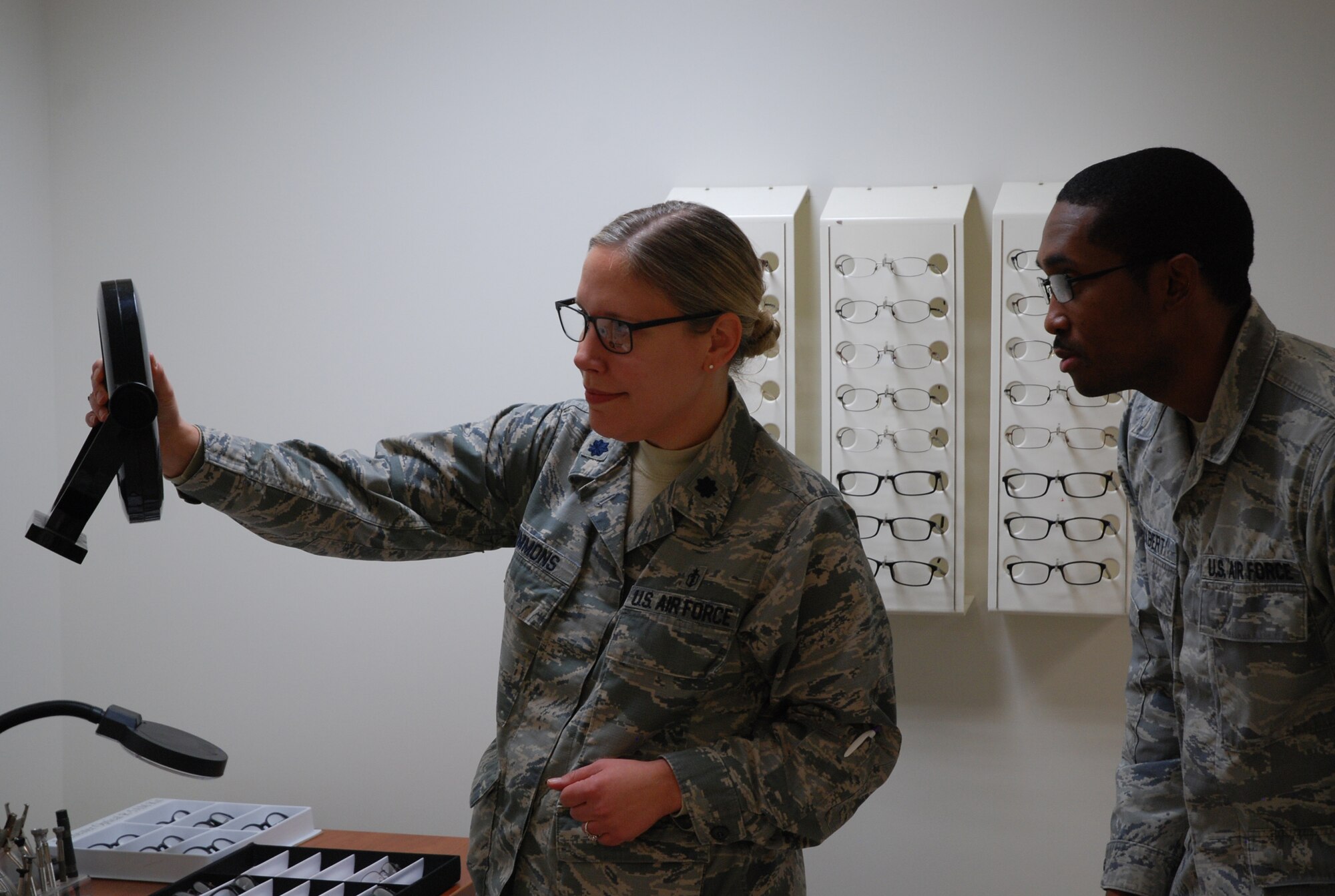 PETERSON AIR FORCE BASE, Colo. - Lt. Col. Melissa Simmons, 21st Aerospace Medicine Squadron optometry flight commander, and Staff Sgt. Dwain Tolbert, 21st AMDS optometry NCOIC, try out frames included in the Frames of Choice demand test. Peterson Air Force Base is one of 10 Air Force Bases participating in the test to determine which frames are most popular and might be added to an expanded selection. (U.S. Air Force photo by Dave Smith)