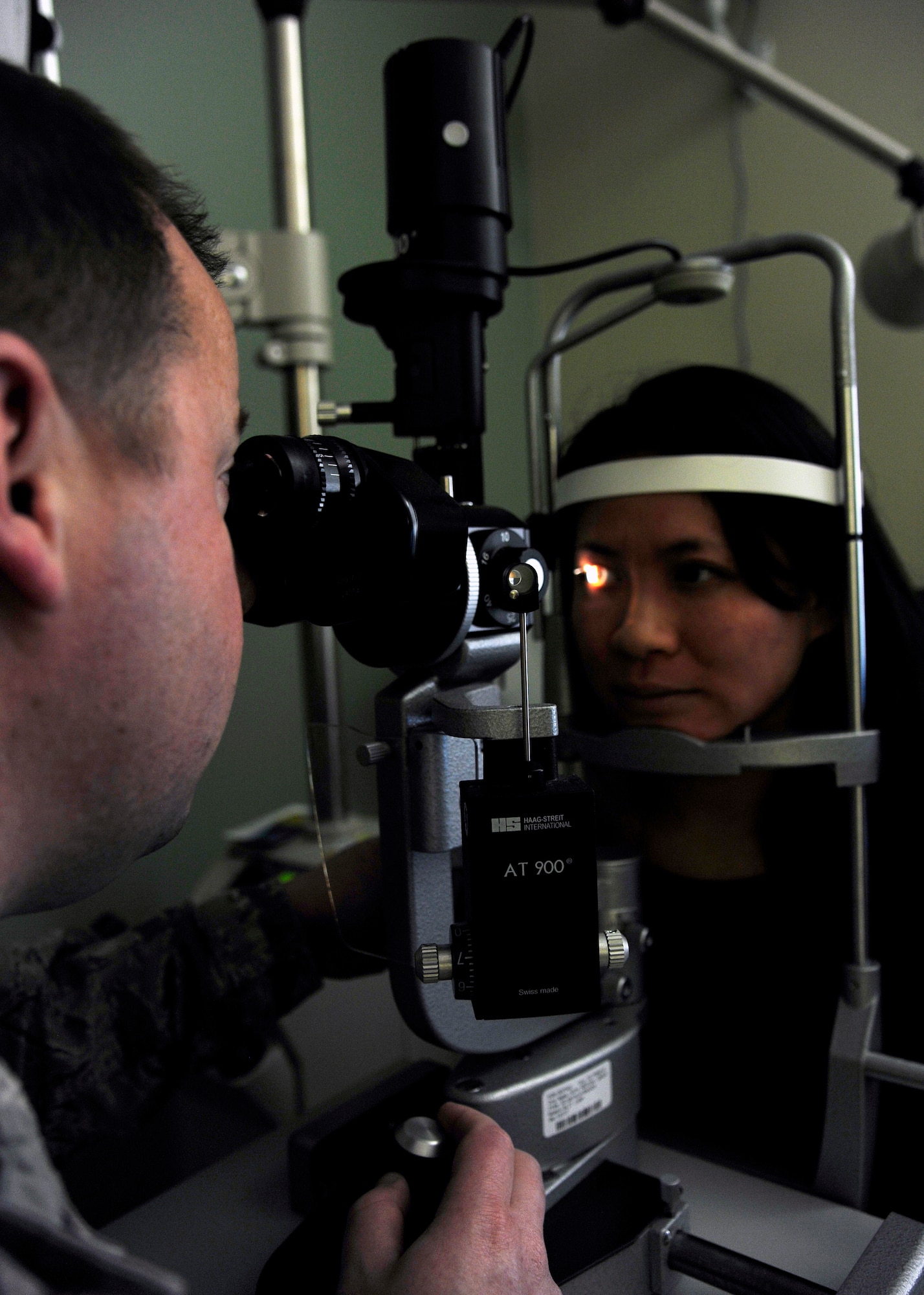 Capt. Richard Reinert, 30th Medical Operations Squadron optometry element chief, simulates an eye exam with Dinna Lea, optometry intern, Jan. 11, 2016, Vandenberg Air Force Base, Calif. The small team of optometrists and technicians at Vandenberg prove to be a vital part of the health and well-being of service members and their families. (U.S. Air Force photo by Senior Airman Kyla Gifford/Released)