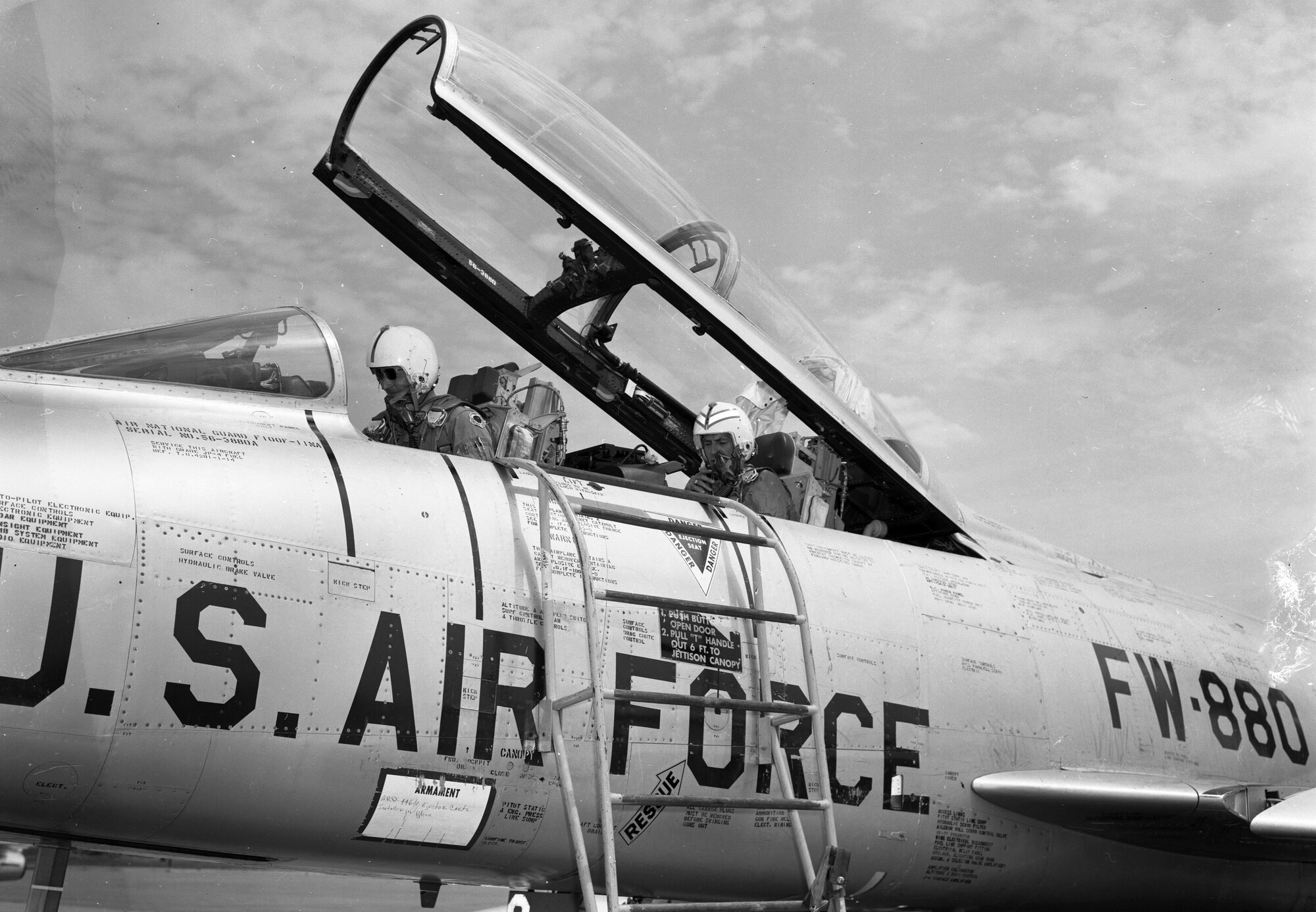 Lt. Col. Warren G. Nelson, 185th Tactical Fighter Group returns from a flight in an F-100F while Iowa Governor Harold Hughes rides in the back seat at the Volk Filed Combat Readiness Training Center in Wisconsin on July 22, 1966. Hughes was treated to a backseat ride in the two seat training model of the F-100 while visiting the unit during their annual summer training. The F-100, tail number 880, was assigned to the Iowa National Guard’s 185th Tactical Fighter Group in Sioux City, Iowa.
U.S. Air National Guard Photo by Airman 1st Class Dwain Volwieler 185th TFG Photographer