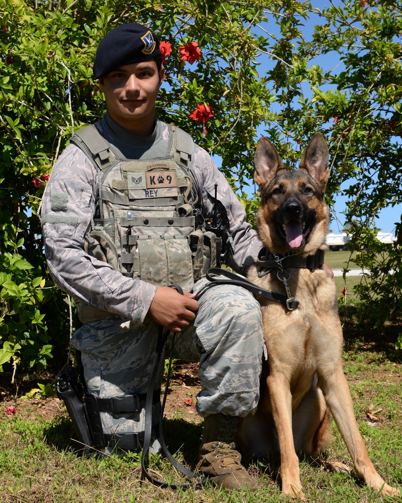 Staff Sgt. Mario Rey, 36th Security Forces Squadron military working dog handler, kneels with his partner Gezu Jan. 14, 2016, at Andersen Air Force Base, Guam. Rey and Gezu were among the team members that recently responded to an incident that occurred off-base at a local high school, which involved authorities from the community as well as the K-9 unit and Explosive Ordnance Disposal flight from Andersen. (U.S Air Force photo/Senior Airman Cierra Presentado)