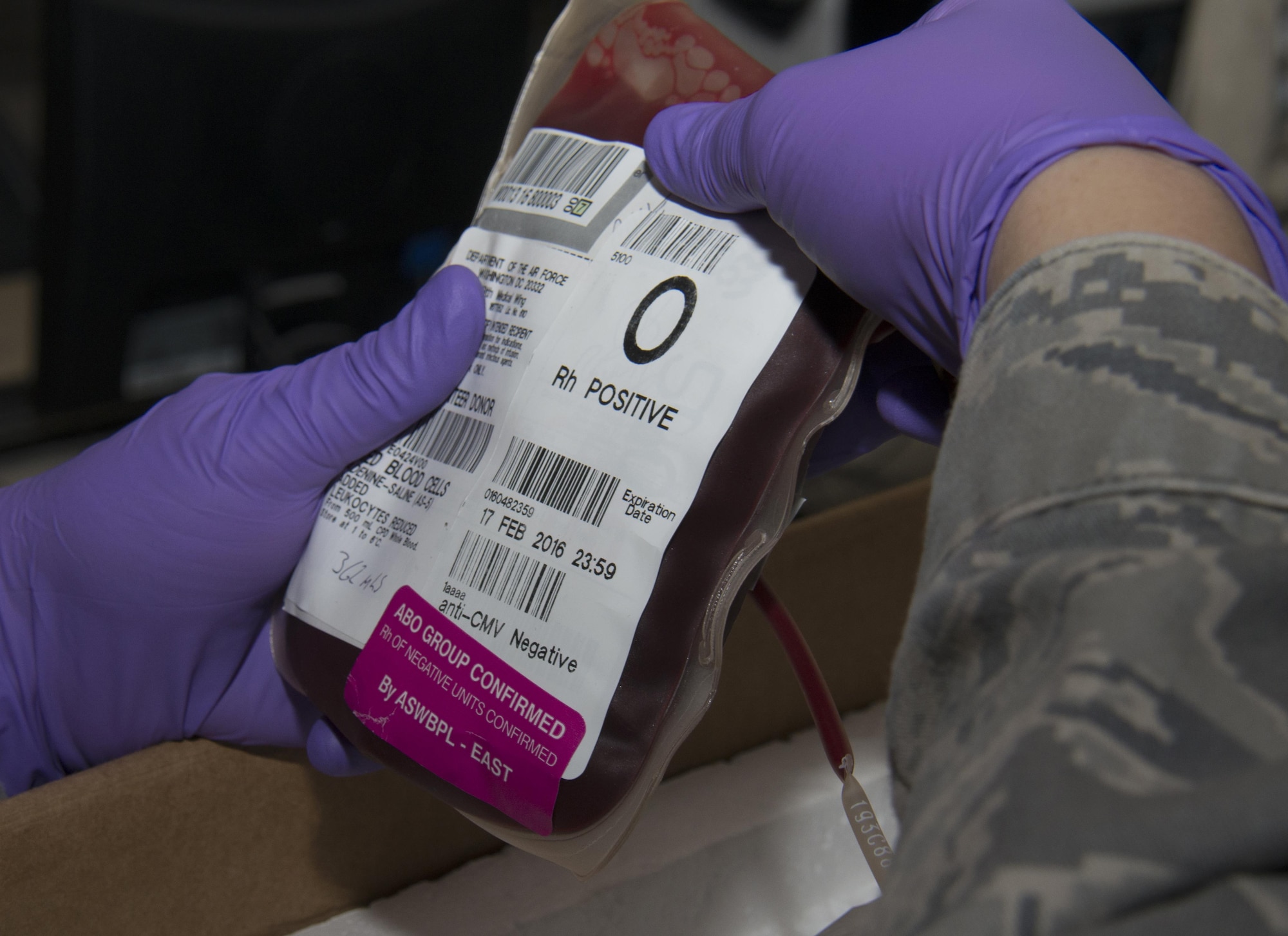 Master Sgt. Stephanie Washington, 379th Expeditionary Medical Support Squadron Diagnostics and Therapeutics flight chief, inspects a red blood cell unit before placing the unit into a box to be shipped at the Blood Transshipment Center at Al Udeid Air Base, Qatar, Jan. 13. The center shipped nearly 23,000 units of blood to more than 30 forward operating locations in the U.S. Central Command area of responsibility in 2015. (U.S. Air Force photo by Tech. Sgt. James Hodgman/Released)