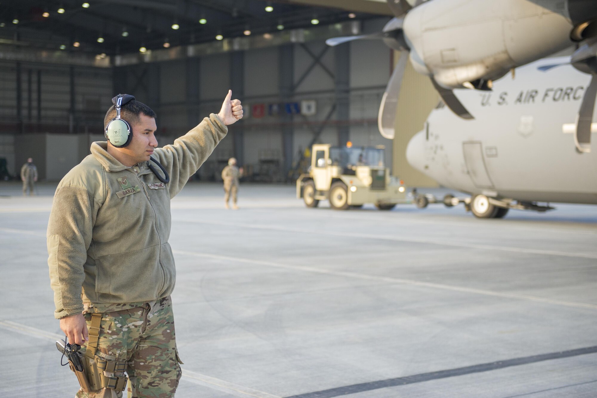 Staff Sgt. Rudy Garza, 455th Expeditionary Aircraft Maintenance Squadron crew chief, guides a C-130J Super Hercules as it is towed to the flightline for an engine test at Bagram Airfield, Aghanistan, Jan. 12, 2016. The 455th EAMXS ensures that Super Hercules at Bagram are prepared for flight and return them to a mission-ready state once they land. (U.S. Air Force photo/Tech. Sgt. Robert Cloys) 
