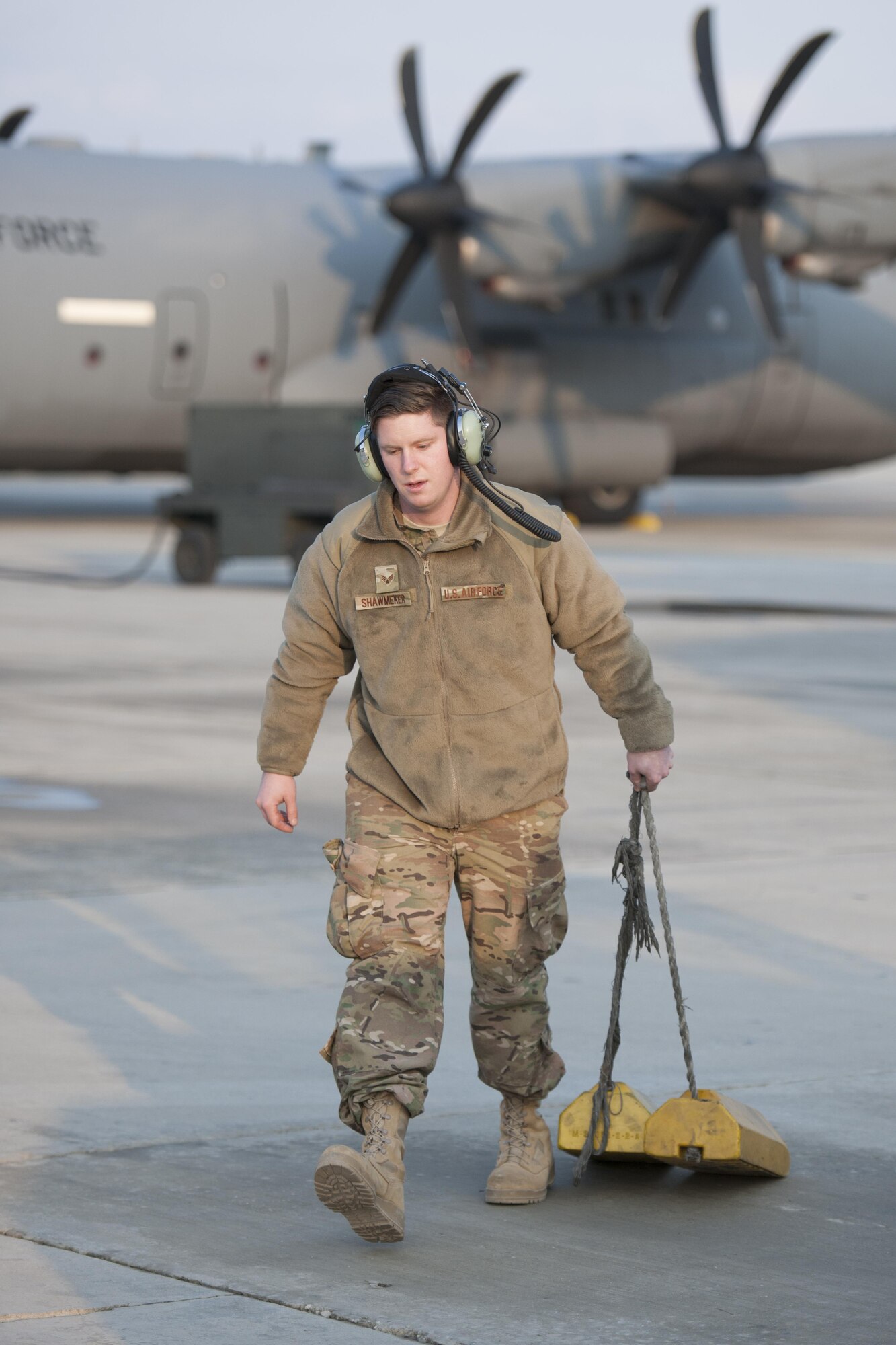 Senior Airman Jeremy Shawmeker, 455th Expeditionary Aircraft Maintenance Squadron crew chief, carries chalks used on a C-130J Super Hercules from the 774th Expeditionary Airlift Squadron at Bagram Airfield, Aghanistan, Jan. 12, 2016. The 455th EAMXS ensures that Super Hercules at Bagram are prepared for flight and return them to a mission-ready state once they land. (U.S. Air Force photo/Tech. Sgt. Robert Cloys) 