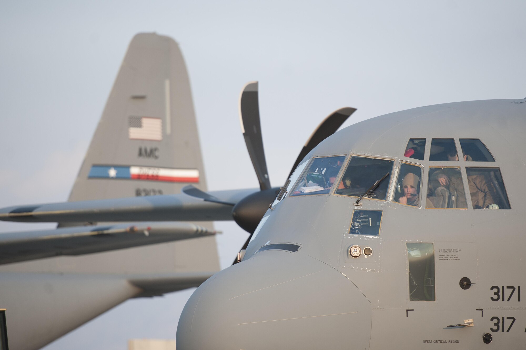 Senior Airman Eric Randall, 455th Expeditionary Aircraft Maintenance Squadron crew chief, sits in the cockpit of a C-130J Super Hercules from the 774th Expeditionary Airlift Squadron as it is towed to the flightline for an engine test at Bagram Airfield, Aghanistan, Jan. 12, 2016. The 455th EAMXS ensures that Super Hercules at Bagram are prepared for flight and return them to a mission-ready state once they land. (U.S. Air Force photo/Tech. Sgt. Robert Cloys) 