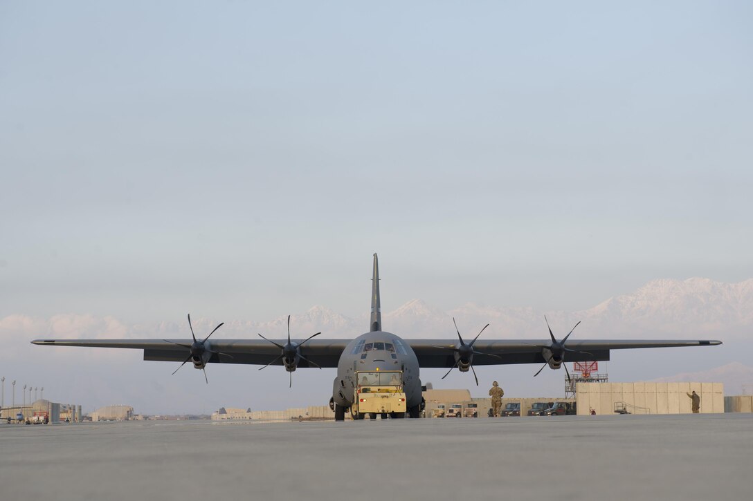Airmen from the 455th Expeditionary Aircraft Maintenance Squadron tow a C-130J Super Hercules from the 774th Expeditionary Airlift Squadron to the flightline for an engine test at Bagram Airfield, Aghanistan, Jan. 12, 2016. The 455th EAMXS ensures that Super Hercules at Bagram are prepared for flight and return them to a mission-ready state once they land. (U.S. Air Force photo/Tech. Sgt. Robert Cloys) 