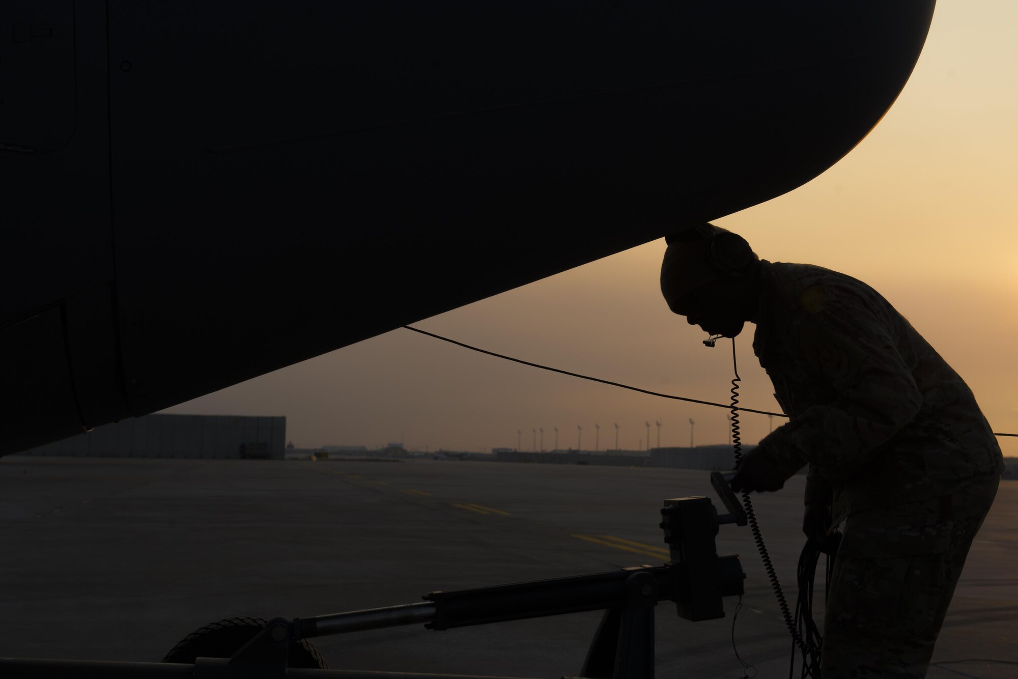 Staff Sgt. Jimmy Hall, 455th Expeditionary Aircraft Maintenance Squadron crew chief, removes the tow bar from a C-130J Super Hercules at Bagram Airfield, Aghanistan, Jan. 12, 2016. The aircraft, used in support of Operation Freedom's Sentinel and NATO's Resolute Support mission, was towed to the flightline for testing after an engine replacement. (U.S. Air Force photo/Tech. Sgt. Robert Cloys) 