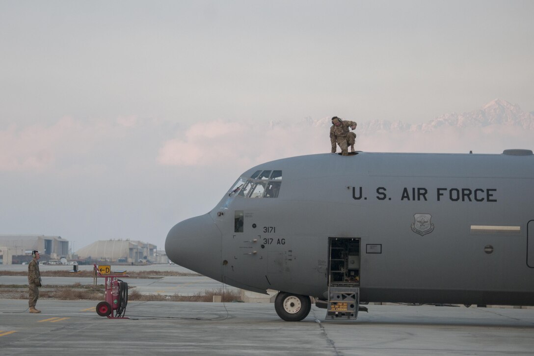 An Airman from the 455th Expeditionary Aircraft Maintenance Squadron climbs through the hatch of a C-130J Super Hercules after an engine test at Bagram Airfield, Aghanistan, Jan. 12, 2016. The 455th EAMXS ensures that Super Hercules at Bagram are prepared for flight and return them to a mission-ready state once they land. (U.S. Air Force photo/Tech. Sgt. Robert Cloys) 