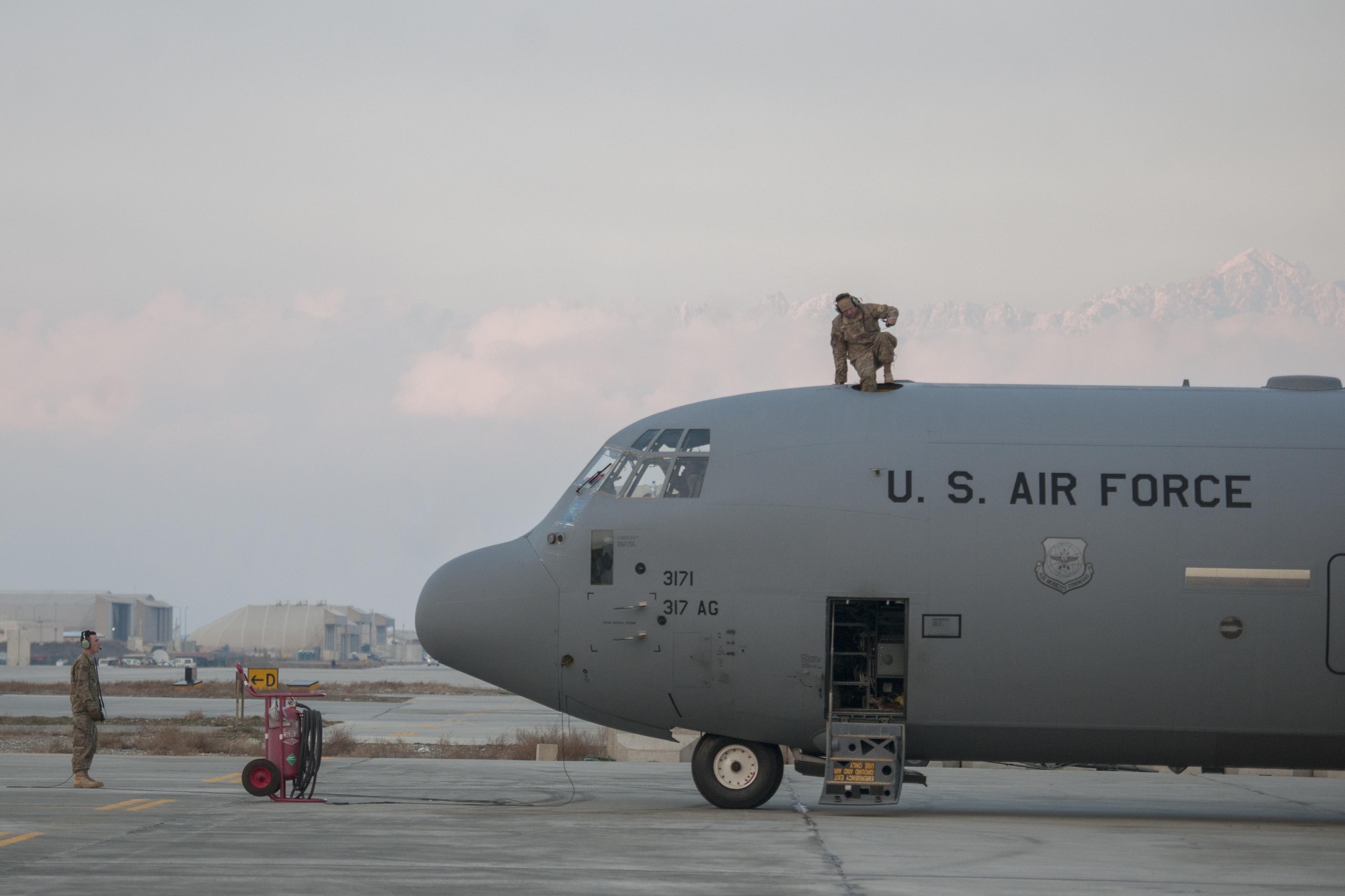 An Airman from the 455th Expeditionary Aircraft Maintenance Squadron climbs through the hatch of a C-130J Super Hercules after an engine test at Bagram Airfield, Aghanistan, Jan. 12, 2016. The 455th EAMXS ensures that Super Hercules at Bagram are prepared for flight and return them to a mission-ready state once they land. (U.S. Air Force photo/Tech. Sgt. Robert Cloys) 