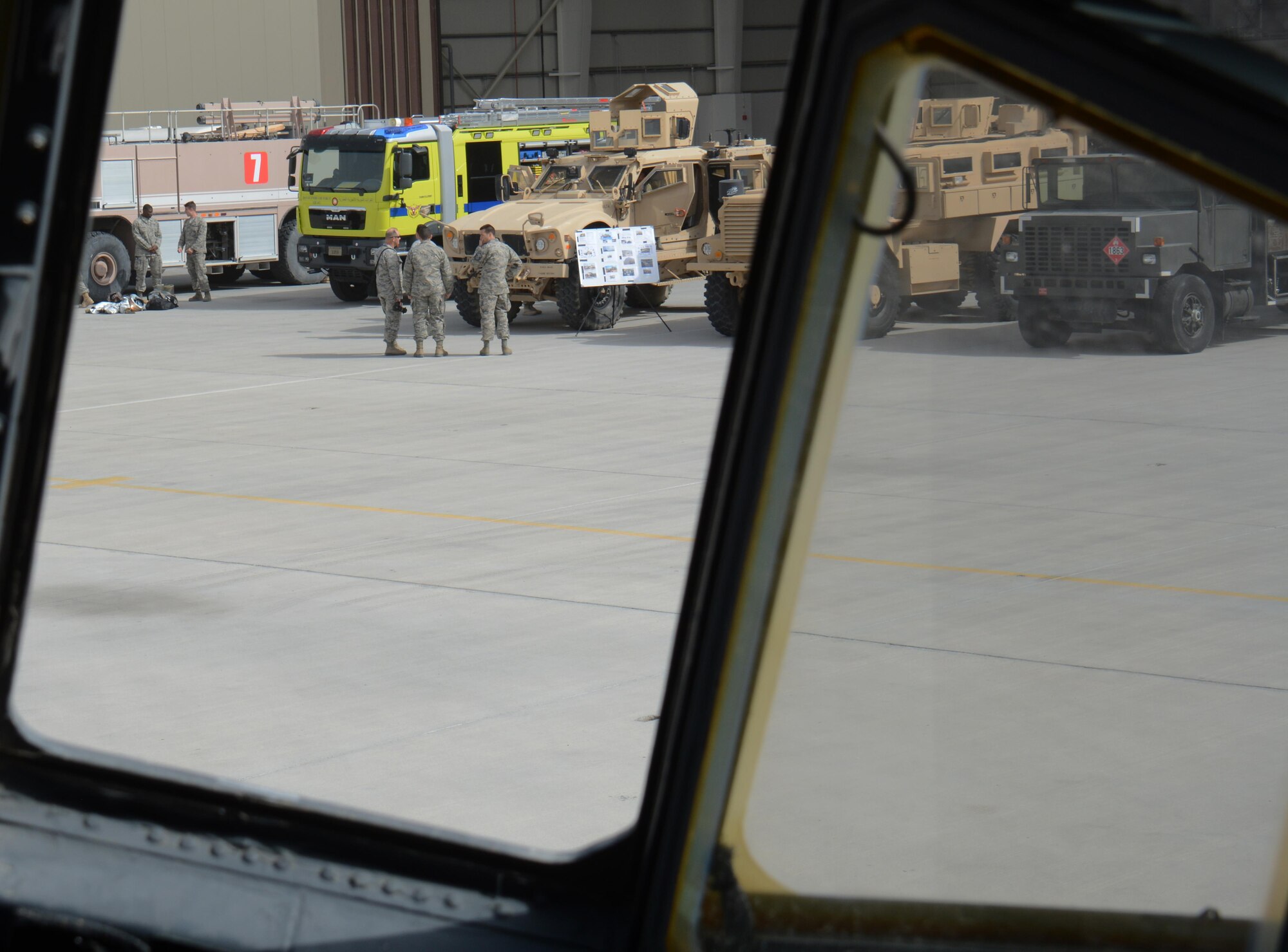 Service members tour several U.S. Air Force and Qatar Emiri Air Force emergency vehicles including fire trucks and mine resistant ambush protectant vehicles, at the annual Flight Line Fest at Al Udeid Air Base, Qatar, Jan. 10. Flight Line Fest is a joint partnership between the 379th Air Expeditionary Wing and QEAF held to foster relations between Qatar and the United States. (U.S. Air Force photo by Tech. Sgt. James Hodgman/Released)