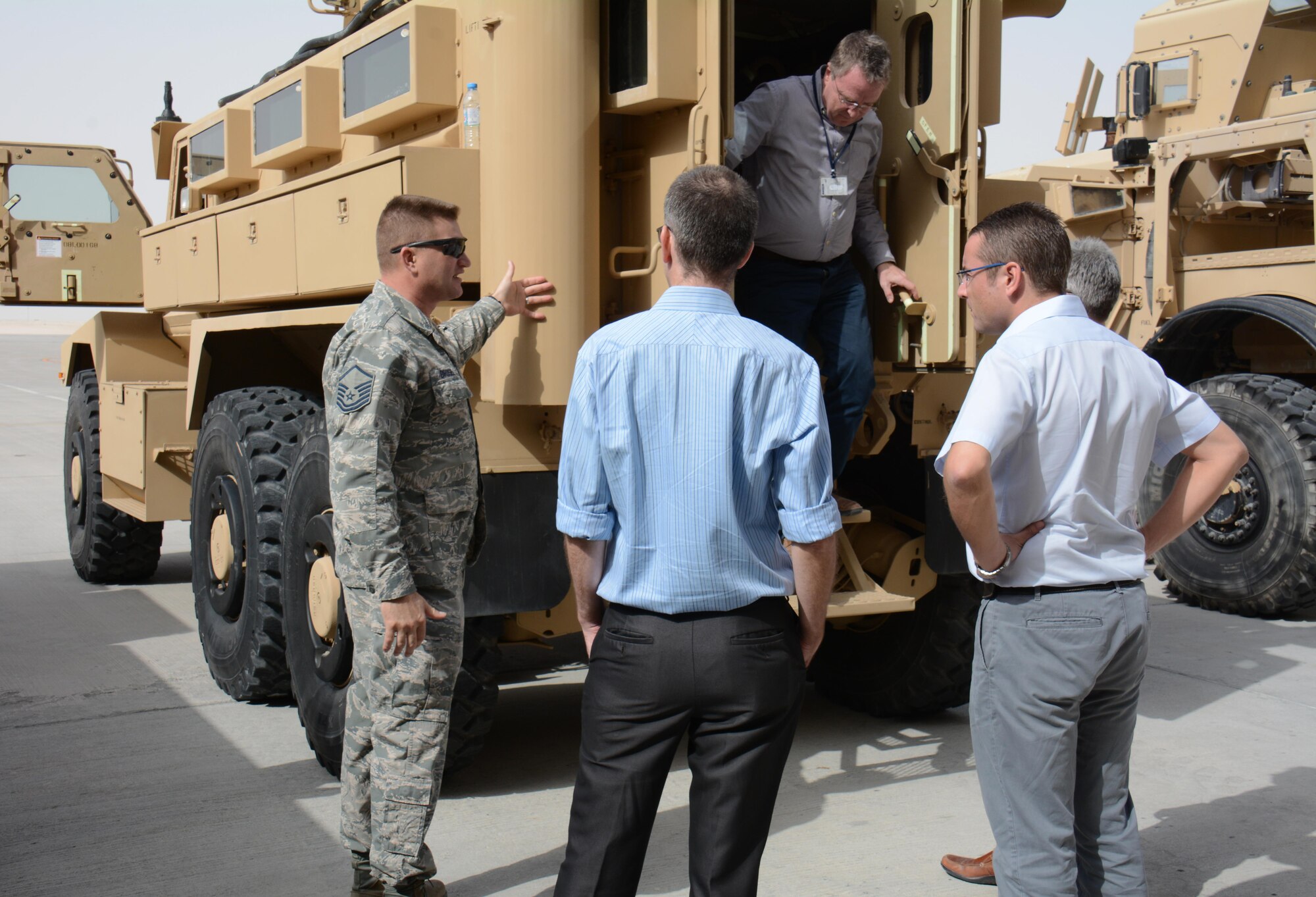 Master Sgt. Sean Birdsell, U.S. Air Force’s Central Detachment 6, shows Flight Line Fest attendees a mine resistant ambush protectant vehicle at Al Udeid Air Base, Qatar, Jan. 10. Birdsell explained that MRAPs are used to protect U.S. service members from attack and have been employed in Iraq and Afghanistan. The vehicle joined several other emergency vehicles and nine aircraft in the annual event, a joint partnership between the 379th Air Expeditionary Wing and Qatar Emiri Air Force held to foster relations between Qatar and the United States. (U.S. Air Force photo by Tech. Sgt. James Hodgman/Released)