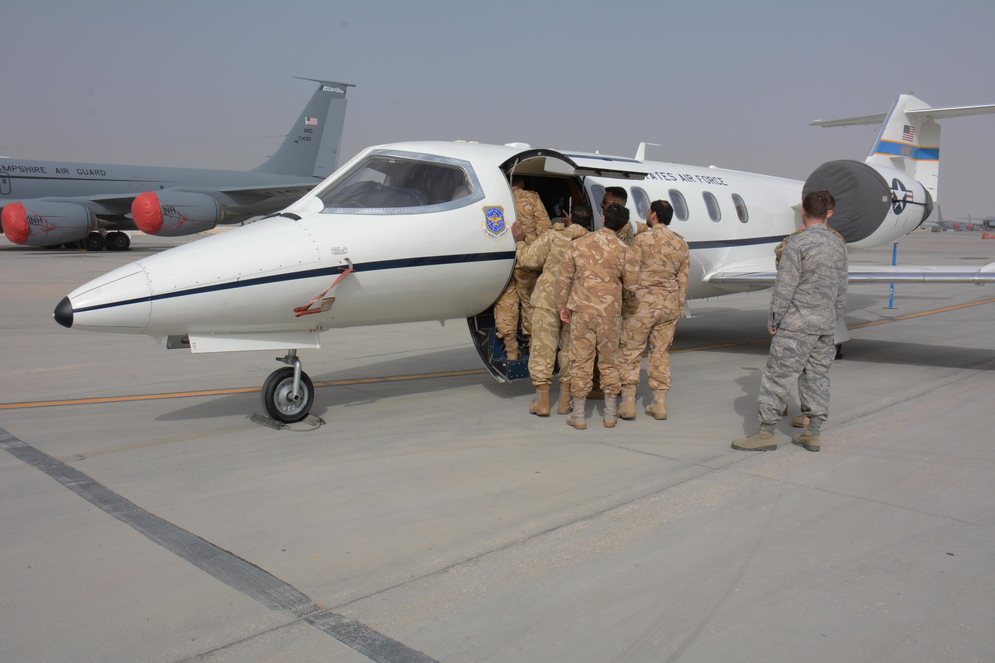 Several members of the Qatar Emiri Air Force tour a C-21 Learjet at the annual Flight Line Fest at Al Udeid Air Base, Qatar, Jan. 10. The aircraft joined eight others in the event, a joint partnership between the 379th Air Expeditionary Wing and QEAF held to foster relations between Qatar and the United States. (U.S. Air Force photo by Tech. Sgt. James Hodgman/Released)