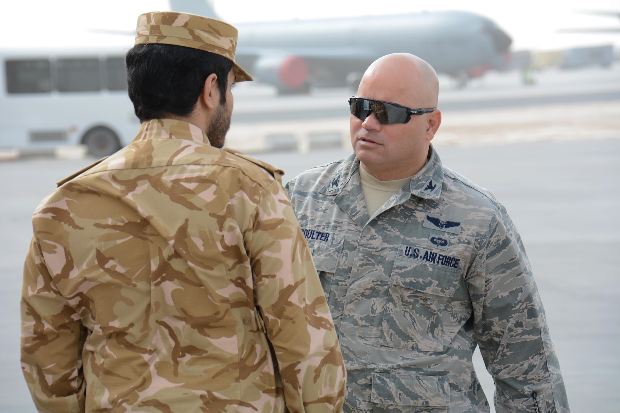 Col. Thomas Goulter, 379th Air Expeditionary Wing Host Nation Coordination Cell director, meets with a member of the Qatar Emiri Air Force at the annual Flight Line Fest Jan. 10 at Al Udeid Air Base, Qatar. The event featured nine aircraft and an emergency vehicle display. Flight Line Fest is a joint partnership between the 379 AEW and QEAF to foster relations between Qatar and the United States. (U.S. Air Force photo by Tech. Sgt. James Hodgman/Released)