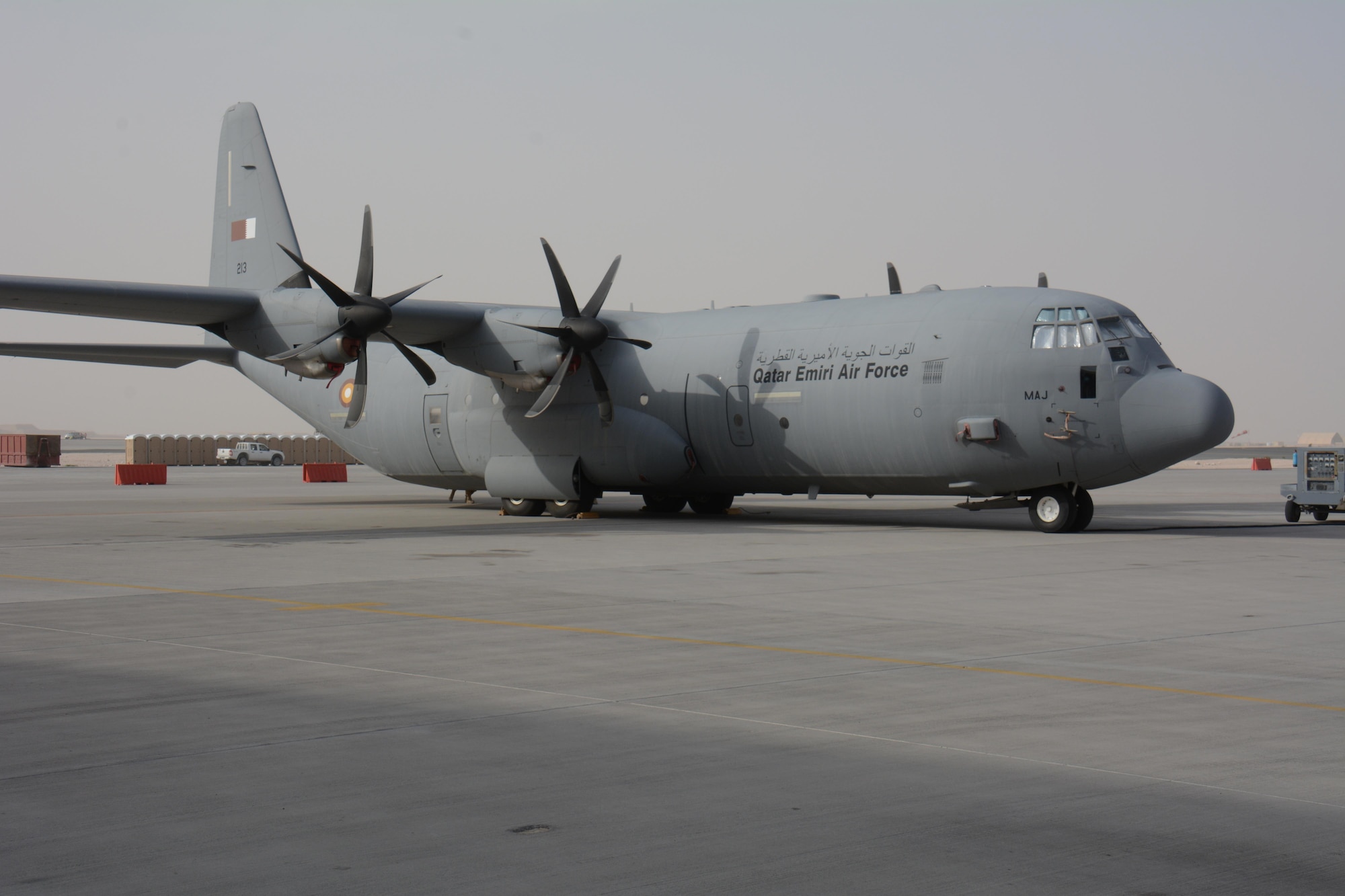 A Qatar Emiri Air Force C-130J waits for visitors at the annual Flight Line Fest Jan. 10 at Al Udeid Air Base, Qatar. The plane, which is used to haul cargo and train paratroopers, was one of four QEAF aircraft on display during the event. Flight Line Fest is a joint partnership between the 379th Air Expeditionary Wing and QEAF held to foster relations between Qatar and the United States. (U.S. Air Force photo by Tech. Sgt. James Hodgman/Released)