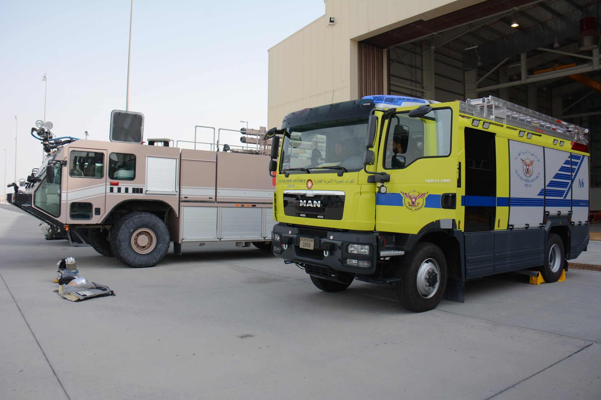 Fire trucks from the Qatar Emiri Air Force and U.S. Air Force wait for visitors at the annual Flight Line Fest Jan. 10 at Al Udeid Air Base, Qatar. The vehicles were part of an emergency vehicle display, which also featured mine resistant ambush protectant vehicles. Nine aircraft including the B-1B Lancer and KC-135 Stratotanker were also on display. Flight Line Fest is a joint partnership between the 379th Air Expeditionary Wing and QEAF held to foster relations between Qatar and the United States. (U.S. Air Force photo by Tech. Sgt. James Hodgman/Released)