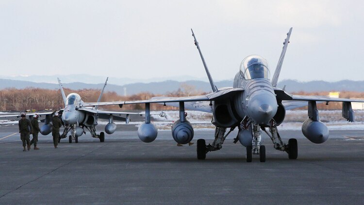 Two F/A-18D Hornets with Marine All-Weather Fighter Attack Squadron  224 taxi down the Chitose Air Base apron after traveling from Marine Corps Air Station Iwakuni, Jan. 12, 2016. VMFA (AW)-224, homebased at MCAS Beaufort, S.C., is temporarily based in Iwakuni on a unit deployment program and deployed to Northern Japan to participate in the Chitose Aviation Training Relocation Exercise, Jan. 12-22. During the exercise, the squadron conducted dissimilar air combat training with and against the Japan Air Self-Defense Force to further support combined interoperability and Pacific theater security cooperation. 