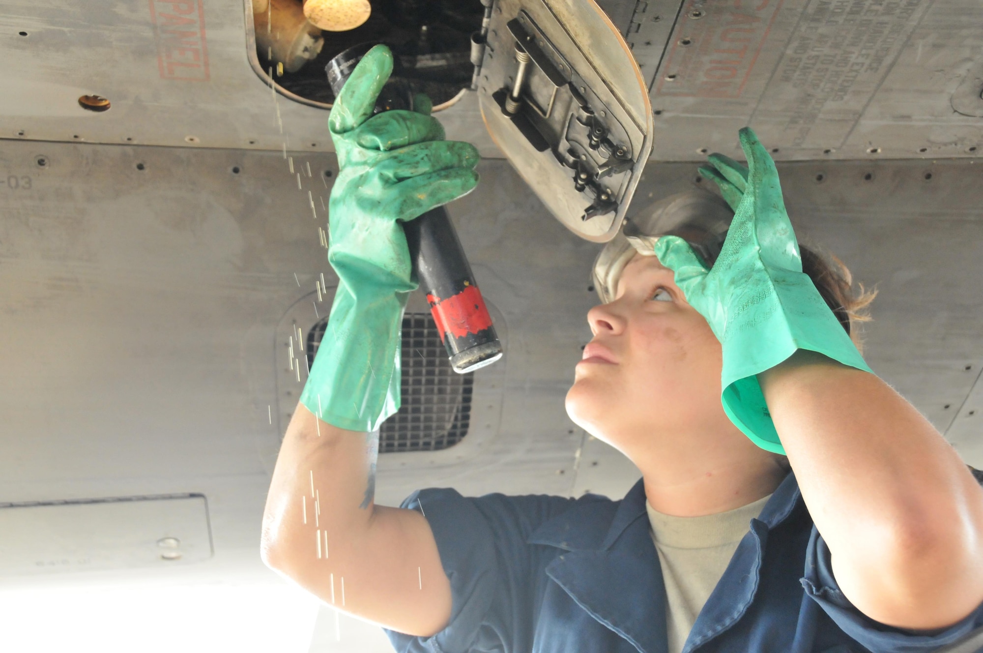 Senior Airman Alexis Anderson, 379th Expeditionary Aircraft Maintenance Squadron crew chief, performs a post-flight inspection on a B-1 B Lancer Jan. 11 at Al Udeid Air Base, Qatar. During the inspection, Anderson services the B-1 with oil. Anderson is deployed from the 307th Expeditionary Aircraft Maintenance Unit at Ellsworth Air Force Base, South Dakota. (U.S. Air Force photo by Tech. Sgt. Terrica Y. Jones/Released)