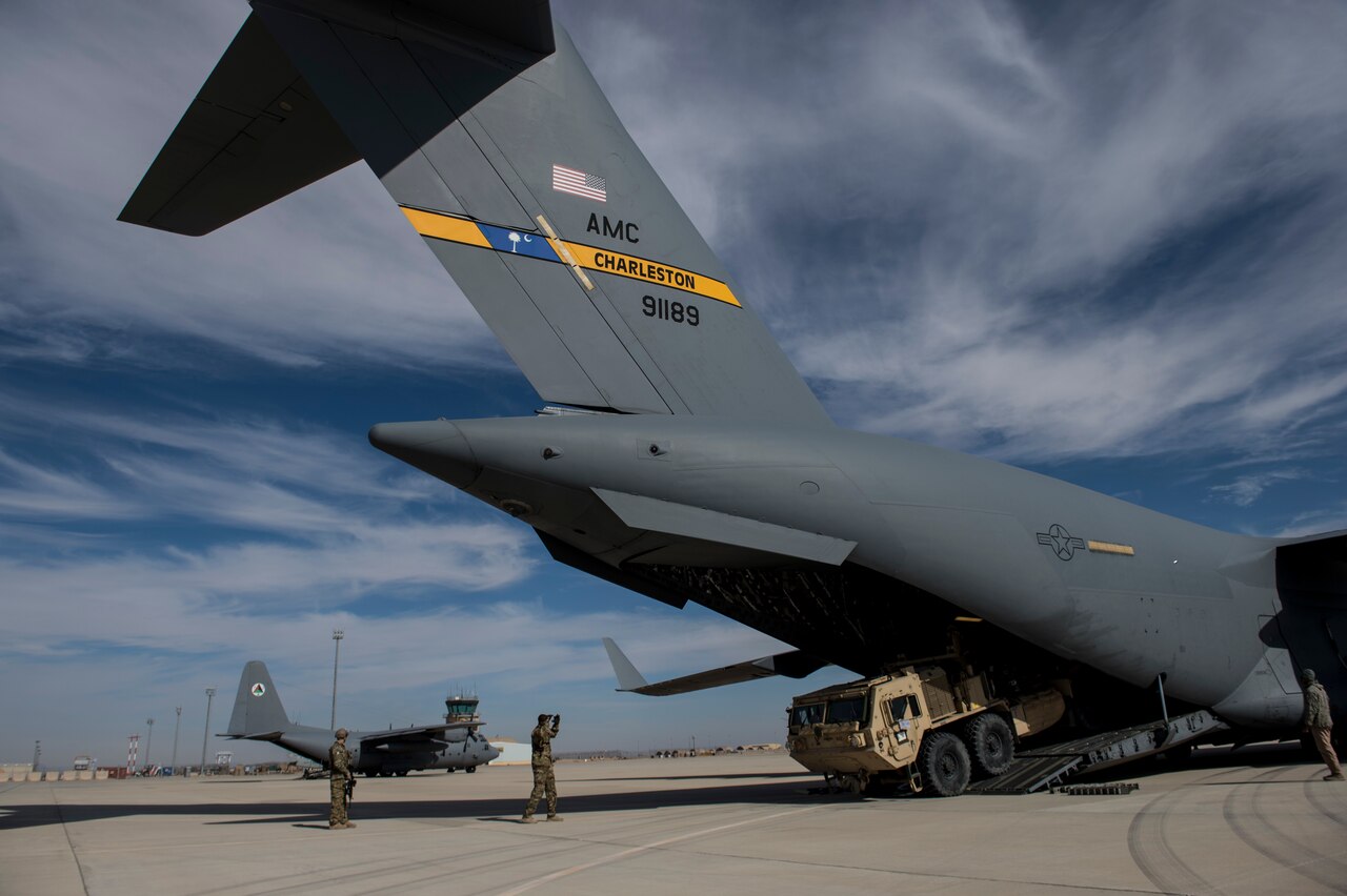 A U.S. airman marshals a truck out of a U.S. Air Force C-17 Globemaster III in Afghanistan, in support of Operation Resolute Support, Jan. 13, 2016. U.S. Air Force photo by Staff Sgt. Corey Hook