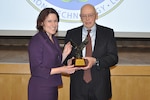 Pictured from left, Defense Procurement and Acquisition Policy Director Claire Grady presents Donald Peschka with the 2015 Under Secretary of Defense for Acquisition, Technology and Logistics Acquisition and Contracting Legends Award during a ceremony at the Pentagon Jan. 12.