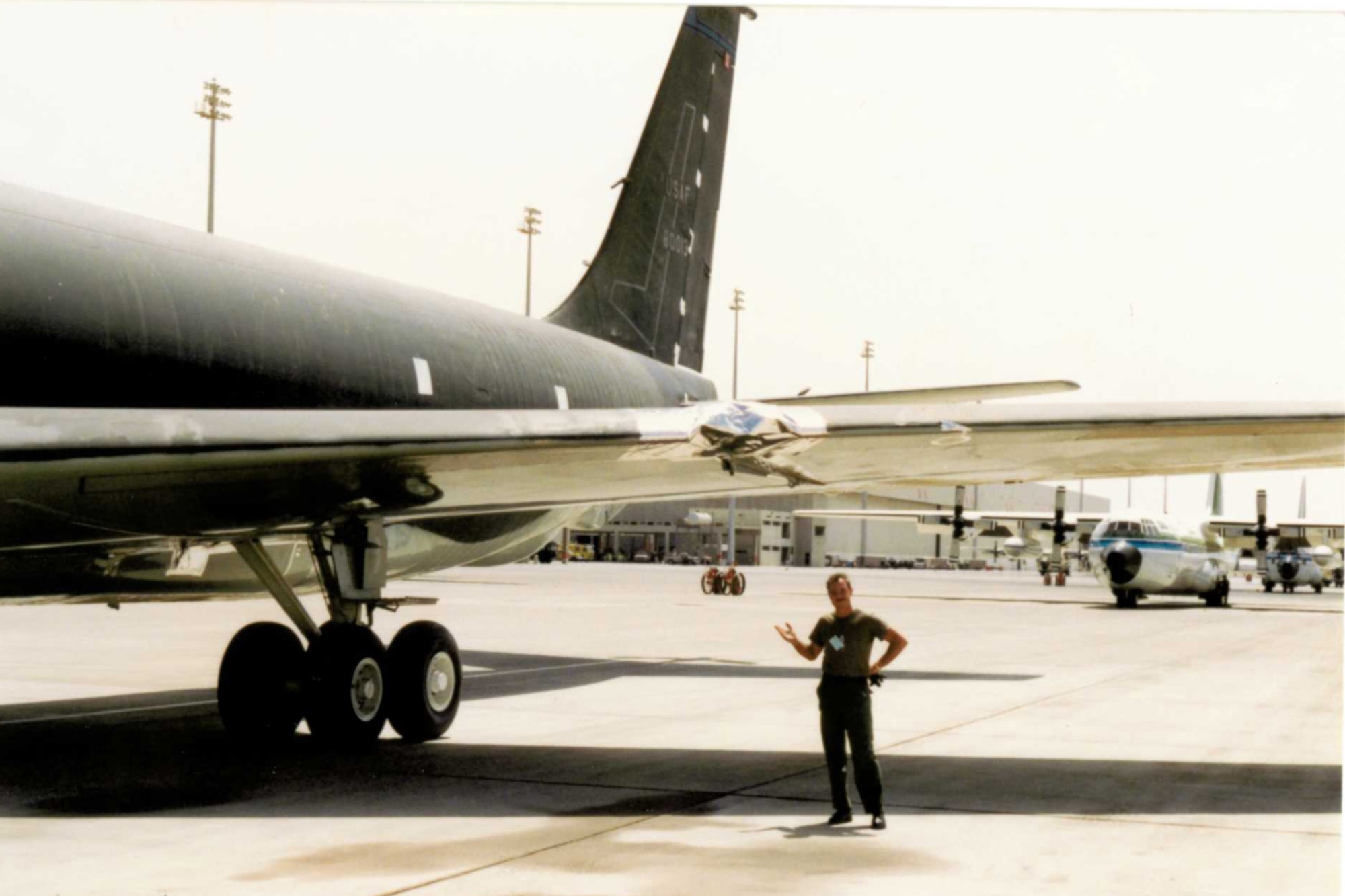 Tech. Sgt. Tim Hill stands next to his  aircraft 58-0013 in Saudi Arabia during Desert Storm. Two of the aircraft's engines departed the aircraft following severe turbulence but was landed safely by the Kansas crew members. (U.S. Air Force photo/courtesy Tim Hill)
