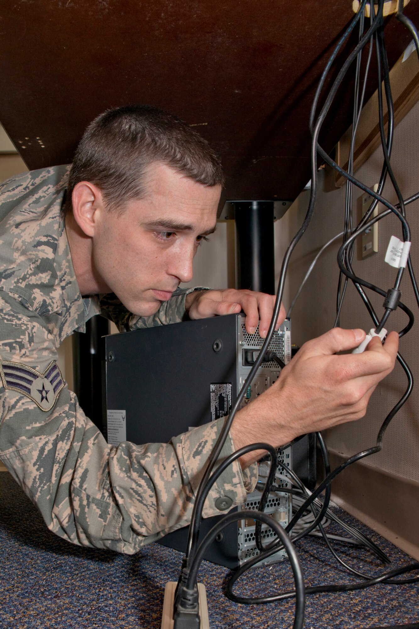 U.S. Air Force Reserve Senior Airman Justin Radford, a client systems technician assigned to the 913th Force Support Squadron, replaces a digital video interface cable with a video graphics adapter cable to connect two monitors on a computer system, Jan. 13, 2016, at Little Rock Air Force Base, Ark. Radford returned to the 913th FSS last week after graduating a 13-week technical school at Keesler Air Force Base, Miss. He will be supports the 913th Airlift Group as an Air Reserve Technician by fixing and installing computer systems in addition to installing software, maintaining hardware and adding new computers to the unit network. (U.S. Air Force photo by Master Sgt. Jeff Walston/Released)    