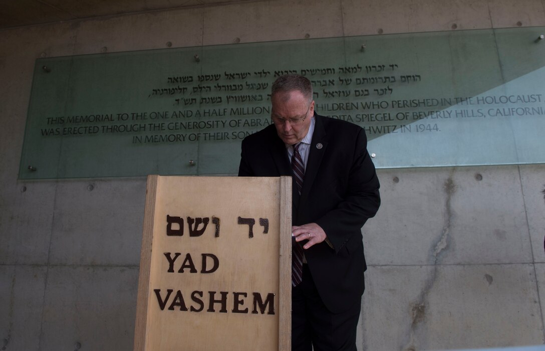 U.S. Deputy Defense Secretary Bob Work signs the guest book after taking part in a wreath-laying ceremony at Yad Vashem, a living memorial to the Holocaust, in Jerusalem, Jan. 14, 2016. DoD photo by Navy Petty Officer 1st Class Tim D. Godbee