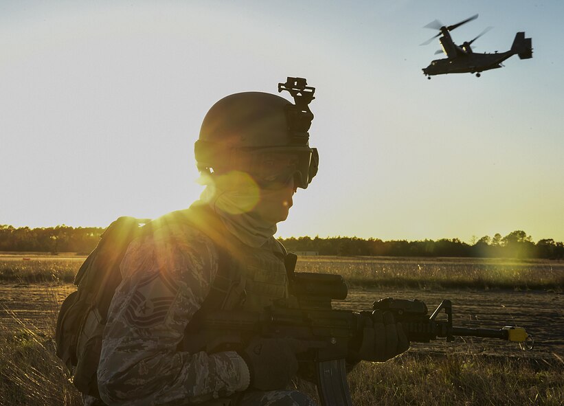 Senior Master Sgt. William Leaf, security forces manager with the 1st Special Operations Security Forces Squadron, sets up a security perimeter for a CV-22 Osprey during exercise Frigid Archer 2016 on Eglin Range, Fla., Jan. 6, 2016. Frigid Archer was a week-long exercise that tested 1st Special Operations Wing Air Commandos' expertise through a myriad of operational and support requirements. (U.S. Air Force photo by Senior Airman Ryan Conroy)  