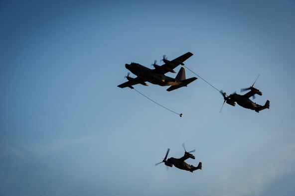 An MC-130H Combat Talon refuels a CV-22B Osprey during the honorary commanders change of command ceremony on Hurlburt Field, Fla., Sept. 25, 2015. The honorary commander program allows local community leaders frequent opportunities to visit Hurlburt Field and learn about the mission, participate in base functions and to express their views on issues of mutual concern. (U.S. Air Force photo by Senior Airman Meagan Schutter)