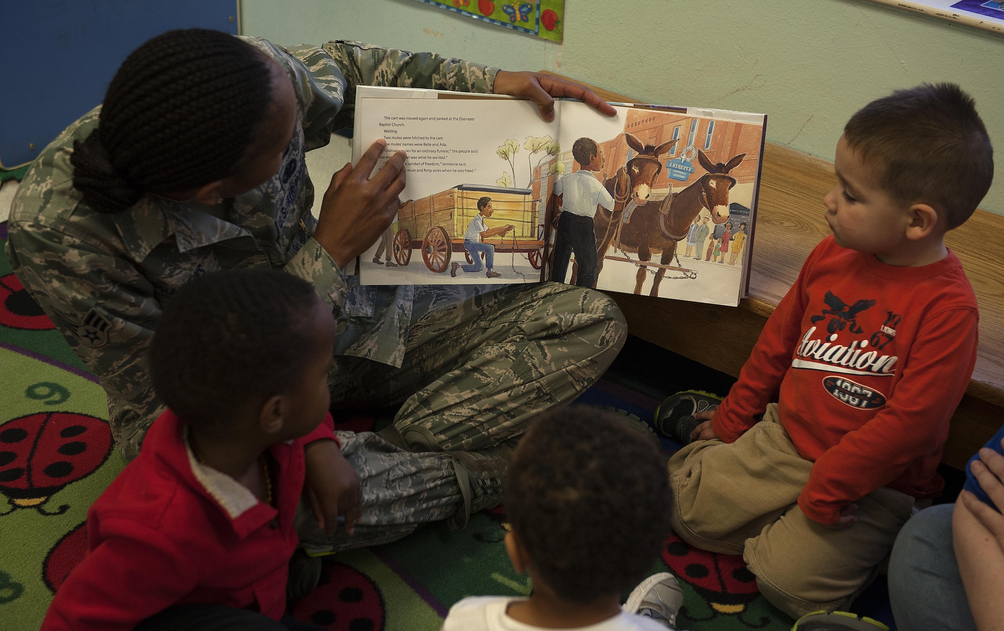 U.S. Air Force Senior Airman Deidra M. Hawkins, 17th Training Wing Safety specialist, reads a book during the Martin Luther King Jr. Book Reading at the Child Development Center on Goodfellow Air Force Base, Texas, Jan. 14, 2016. Hawkins taught the children historical stories about Martin Luther King Jr. (U.S. Air Force photo by Airman 1st Class Caelynn Ferguson/Released)