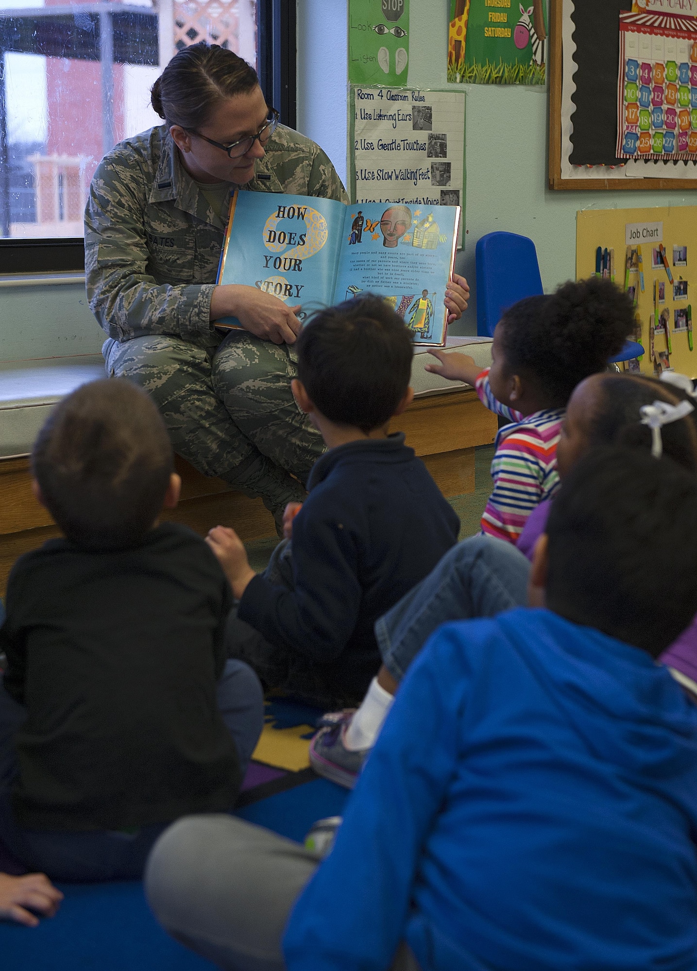 U.S. Air Force 1st Lt. Suzanne M. Bates, Tricare Operations and Patient Administration Flight Commander, reads to children during the Martin Luther King Jr. Book Reading at the Child Development Center on Goodfellow Air Force Base, Texas, Jan. 14, 2016. Service members read books to each class according to their general reading level and age group. (U.S. Air Force photo by Airman 1st Class Caelynn Ferguson/Released)