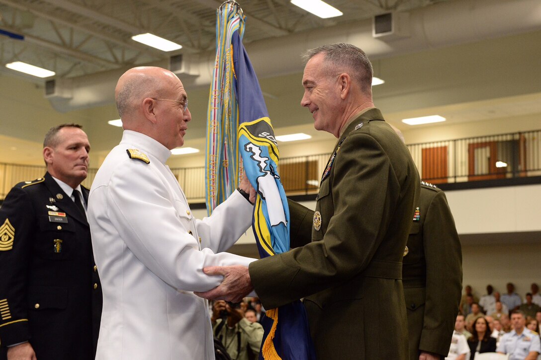 Marine Corps Gen. Joseph F. Dunford Jr., chairman of the Joint Chiefs of Staff, passes command of U.S. Southern Command to Navy Adm. Kurt W. Tidd at the command's headquarters in Miami, Jan. 14, 2016. Tidd assumed command from retiring Marine Corps Gen. John F. Kelly. DoD photo by EJ Hersom