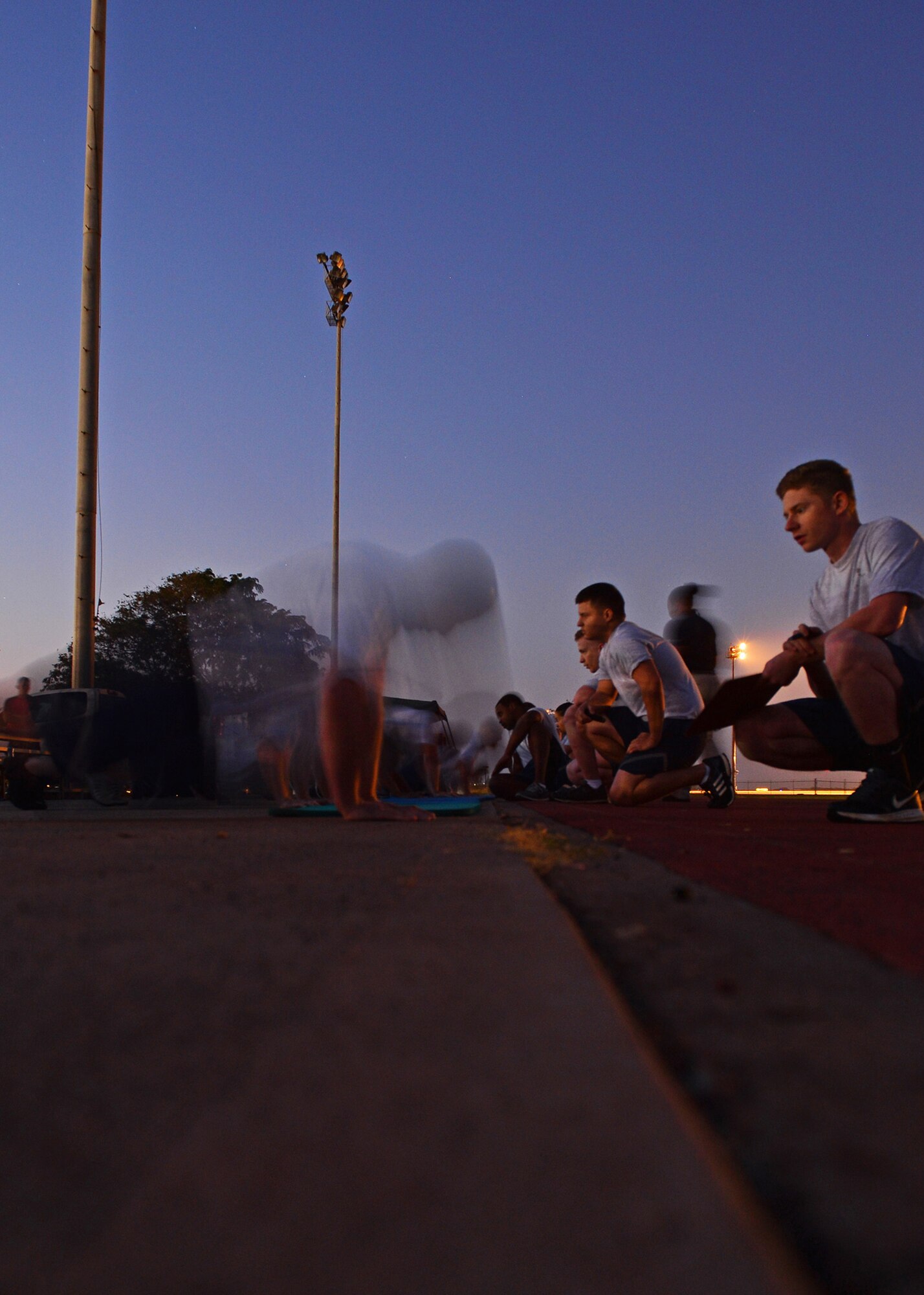 Airmen from the 15th Wing perform push-ups, one of the four fitness componentsof the Air Force fitness assessment at Earhart Field on Joint Base Pearl Harbor-Hickam, Hawaii, Jan. 14, 2016. The goal of the Fitness Program is to motivate all members to participate in a year round physical conditioning program that emphasizes total fitness, to include proper aerobic conditioning, muscular fitness training, and healthy eating. (U.S. Air Force photo by Tech. Sgt. Aaron Oelrich/Released)   