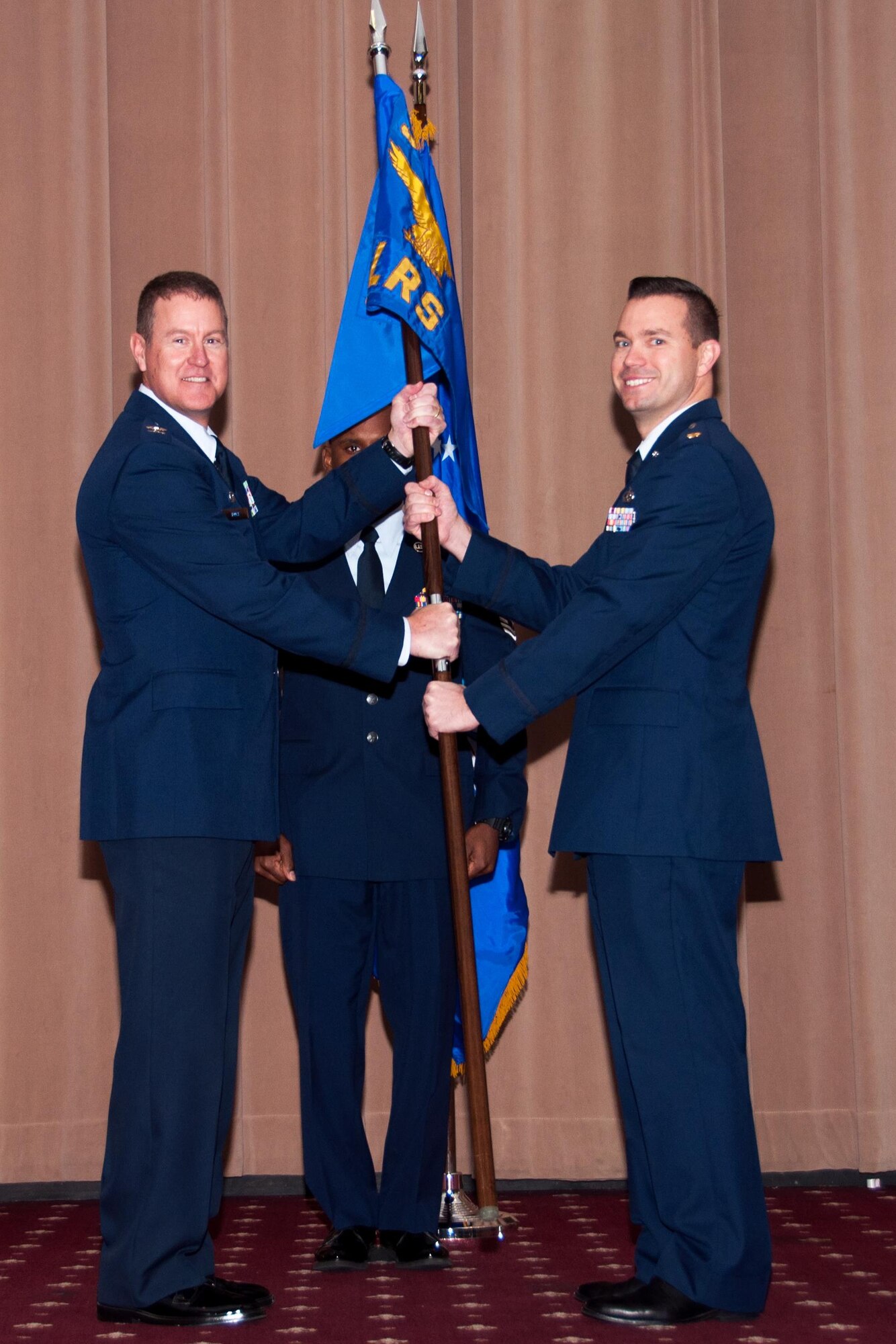 U.S. Air Force Col. William A. Rock (left), 307th Mission Support Group commander, presents the 307th Logistics Readiness Squadron guidon to Maj. Charles R. DeLongchamp III during a change of command ceremony, Jan. 9, 2016, Barksdale Air Force Base, La. DeLongchamp is assuming command of 307th Logistics Readiness Squadron at Barksdale after being assigned to the 10th Air Force, Naval Air Station Joint Reserve Base Fort Worth, Texas as the Logistics Readiness Division Chief. (U.S. Air Force photo by Master Sgt. Laura Siebert /Released)