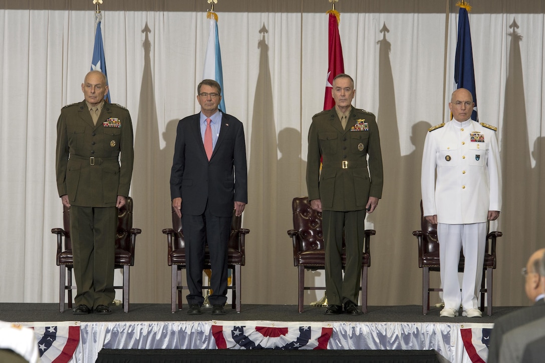 Left to right: Marine Corps Gen. Joseph F. Dunford Jr., chairman of the Joint Chiefs of Staff; Defense Secretary Ash Carter; Marine Corps Gen. John F. Kelly; and Navy Adm. Kurt W. Tidd stand at attention during the change-of-command ceremony at U.S. Southern Command headquarters in Miami, Jan. 14, 2016. DoD News photo by EJ Hersom