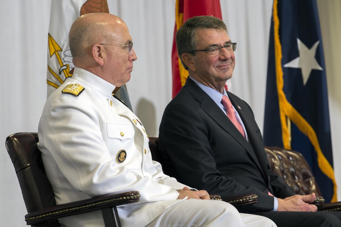 Defense Secretary Ash Carter and U.S. Navy Adm. Kurt W. Tidd listen to remarks during the change-of-command ceremony for the U.S. Southern Command at the command's headquarters in Miami, Jan. 14, 2016. DoD News photo by EJ Hersom