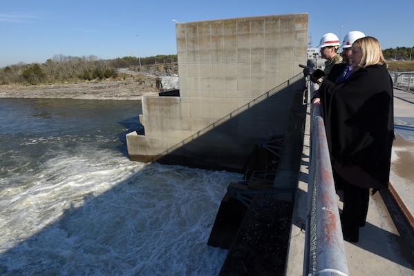 Nashville Mayor Megan Barry stands on top of Old Hickory Dam and looks downstream as the dam spills water into the Cumberland River Jan. 14, 2016.  Lt. Col. Stephen Murphy, U.S. Army Corps of Engineers Nashville District commander, and Ben Rohrbach, Nashville District chief of Hydraulics and Hydrology, provide information about the district's water management operations.