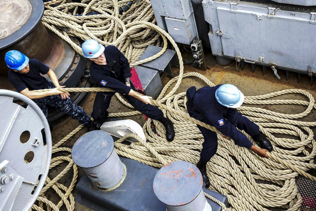 U.S. sailors heave a line on the fantail of the USS Kearsarge in the Gulf of Oman, Jan. 12, 2016. The Kearsarge is supporting security efforts in the U.S. 5th Fleet area of responsibility. U.S. Navy photo by Seaman Dana D. Legg